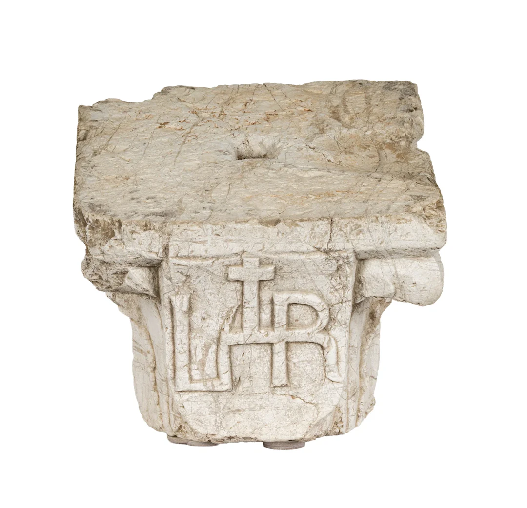 A Romanesque Carved Limestone Capital with Heraldic Shield