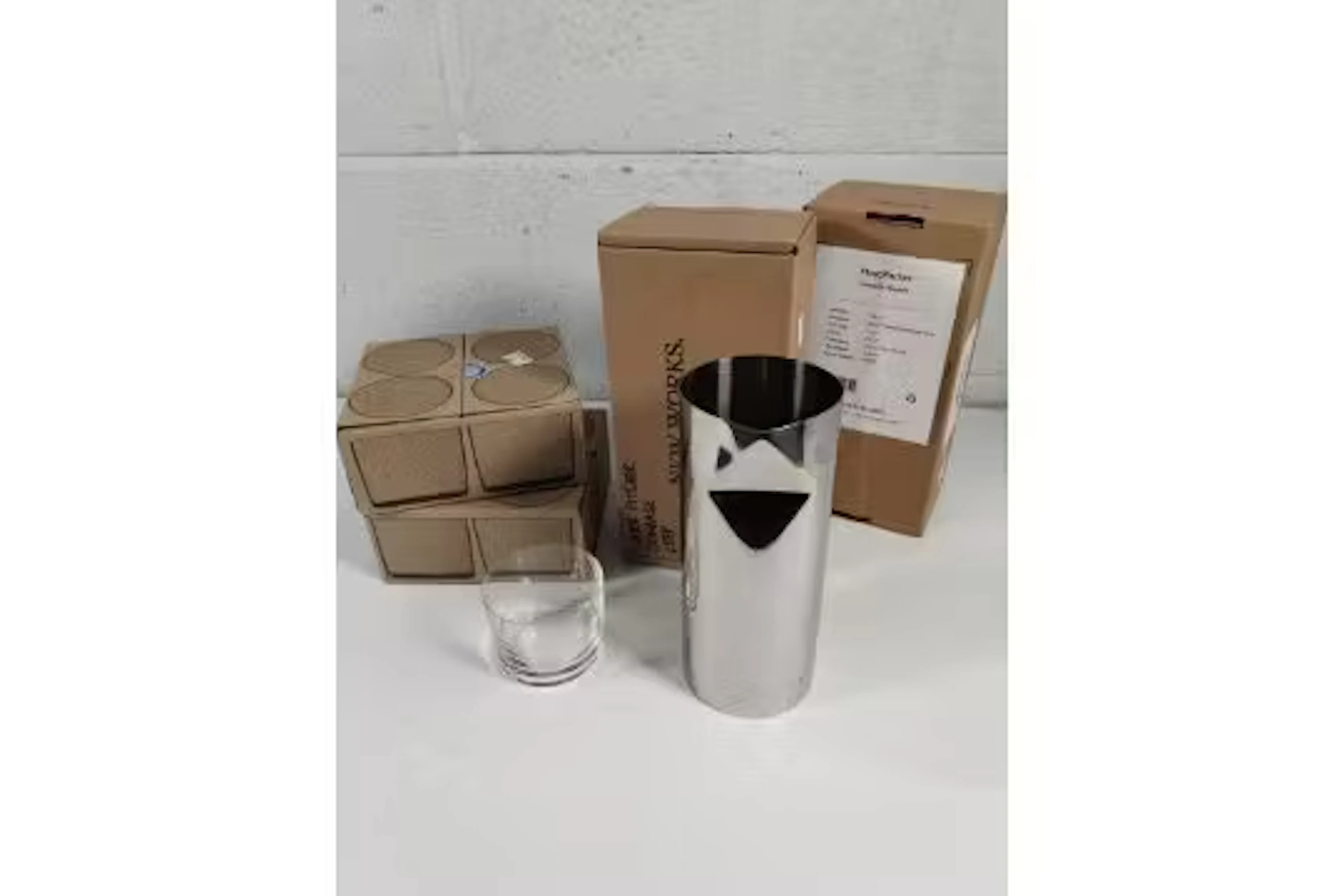 Two New Works stainless steel pleat pitchers and two boxes of four