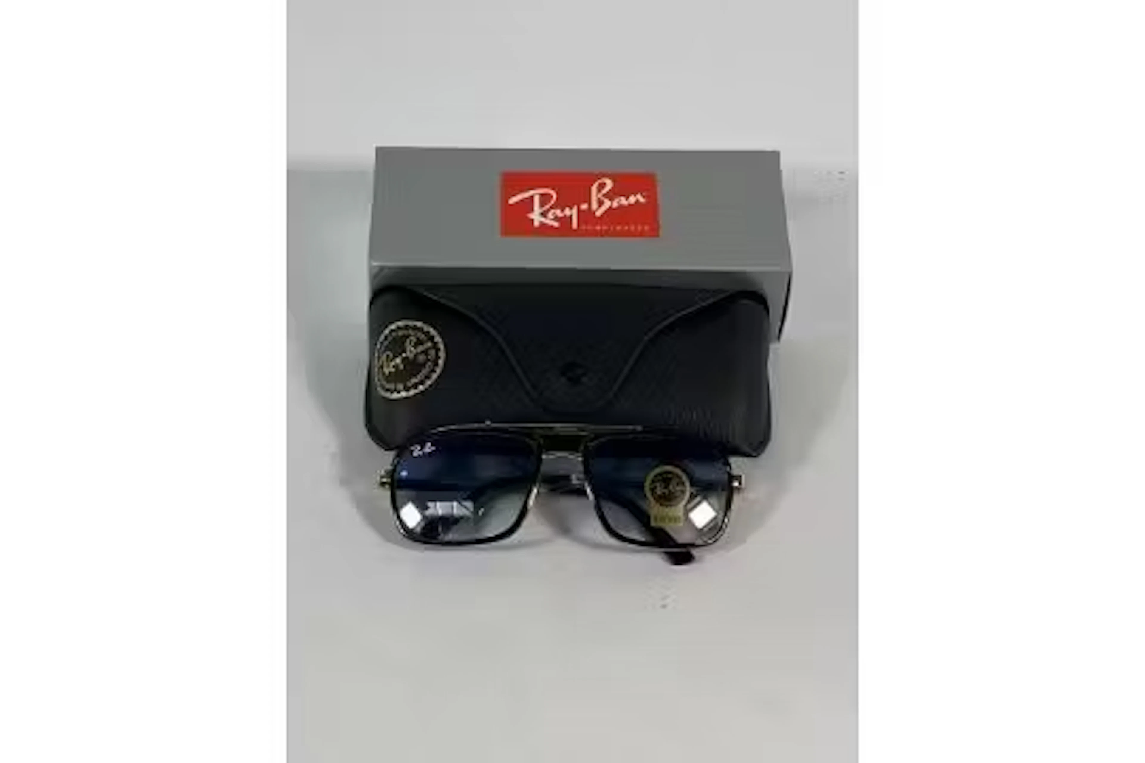 A pair of Ray-Bans Square sunglasses in polished gold and black with
