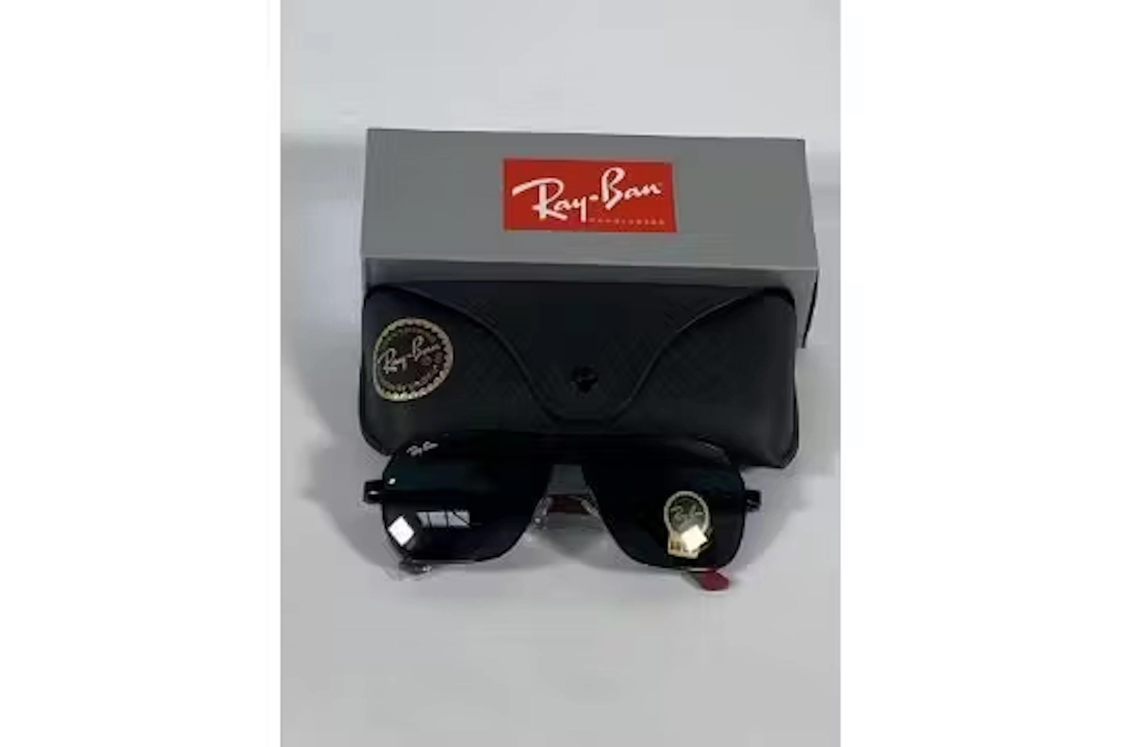 A pair of Ray-Bans Square sunglasses in black and red with green classic