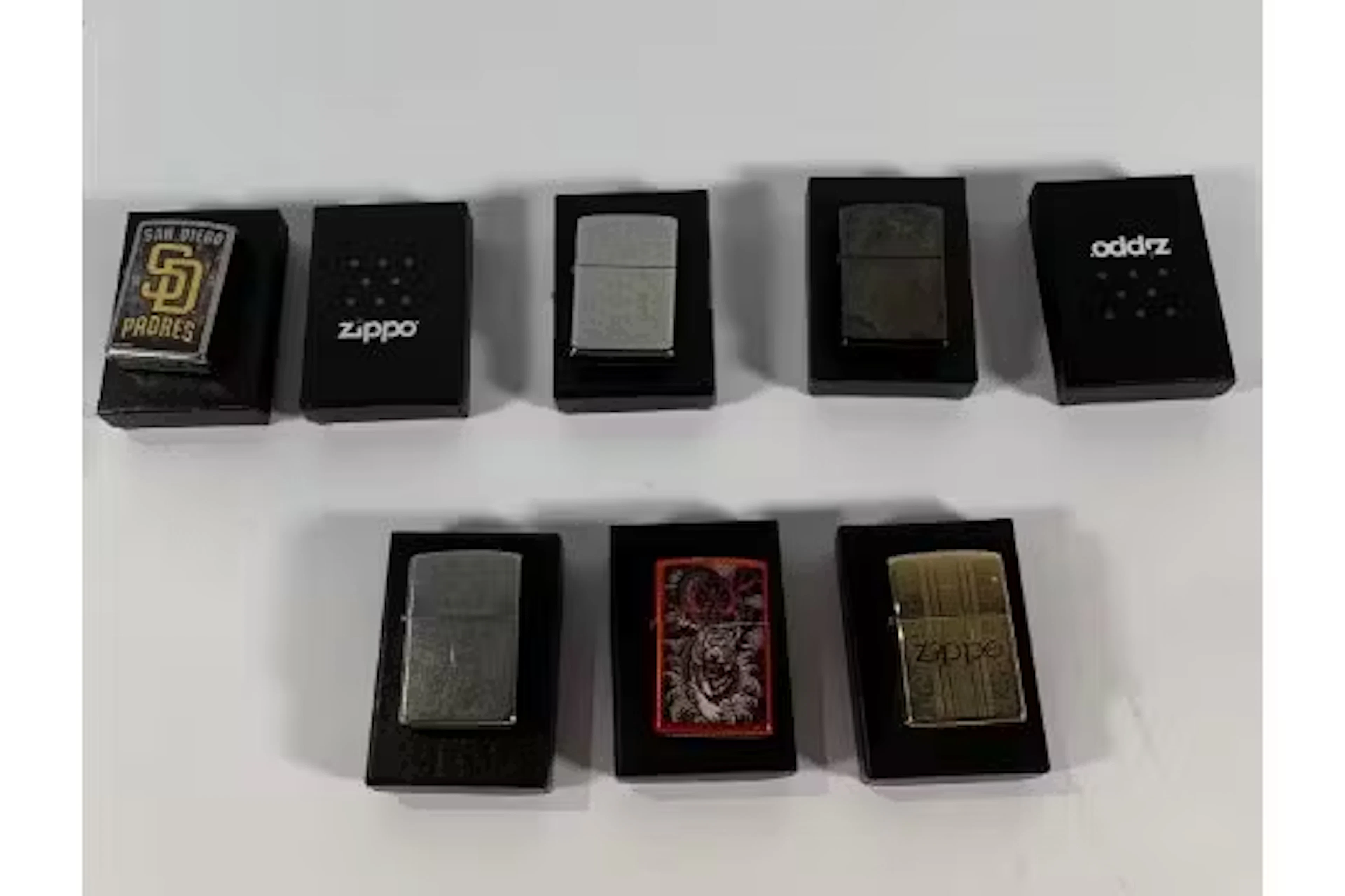 Eight Zippo lighters in boxes (over 18s only).