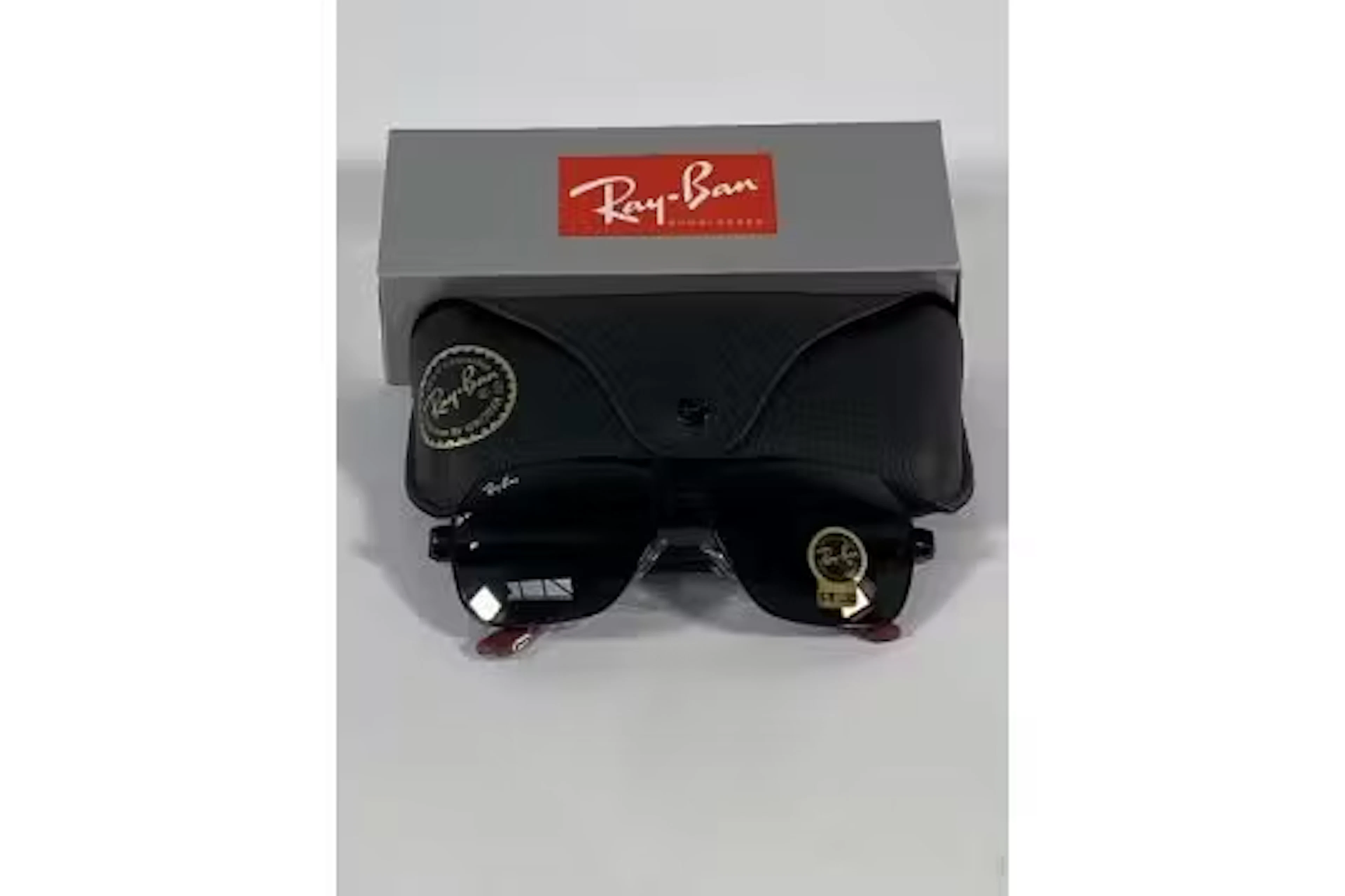 A pair of Ray-Bans Square sunglasses in black and red with green classic