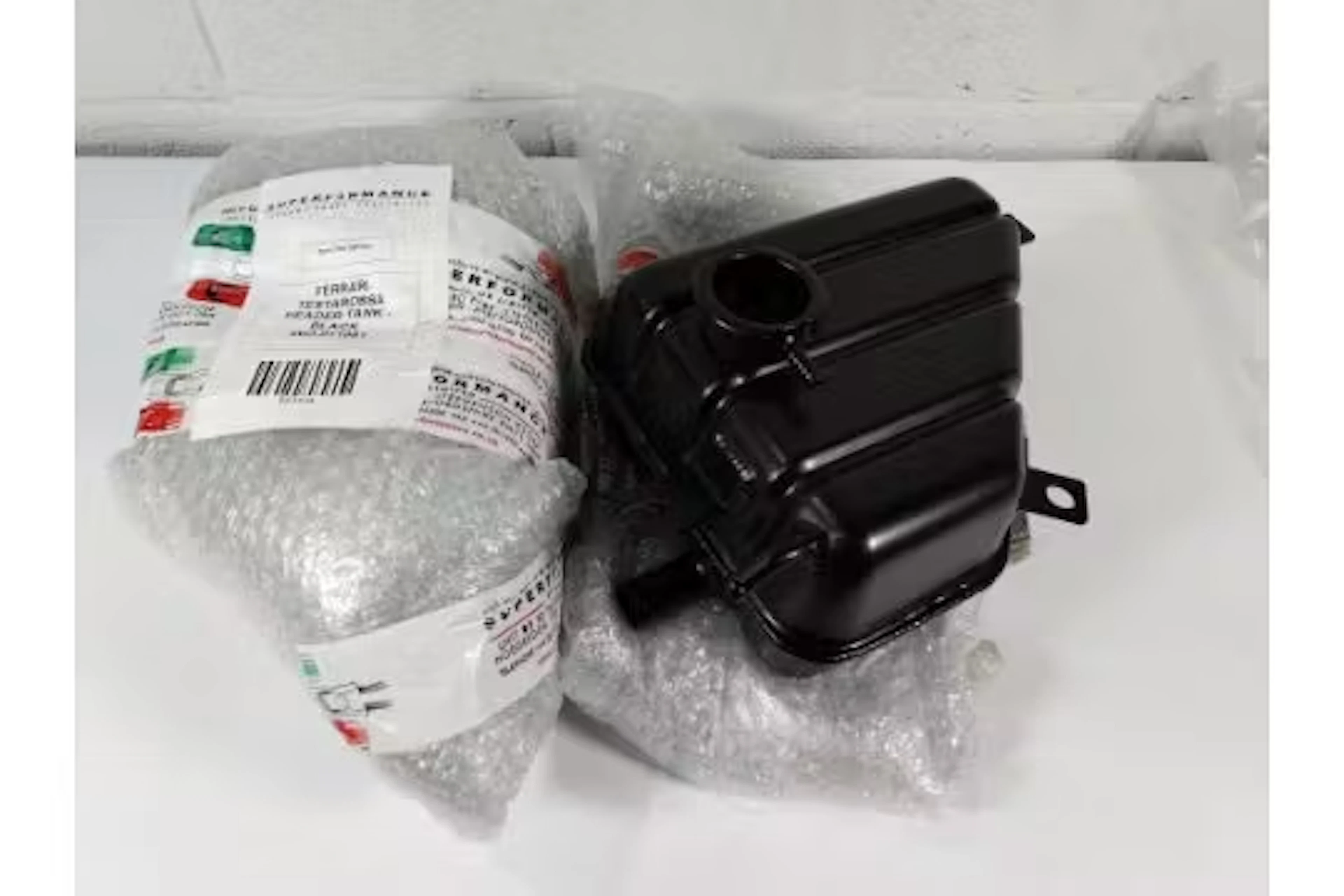 Two as new Ferrari Testarossa header tanks (bare units) WO-011981, black.