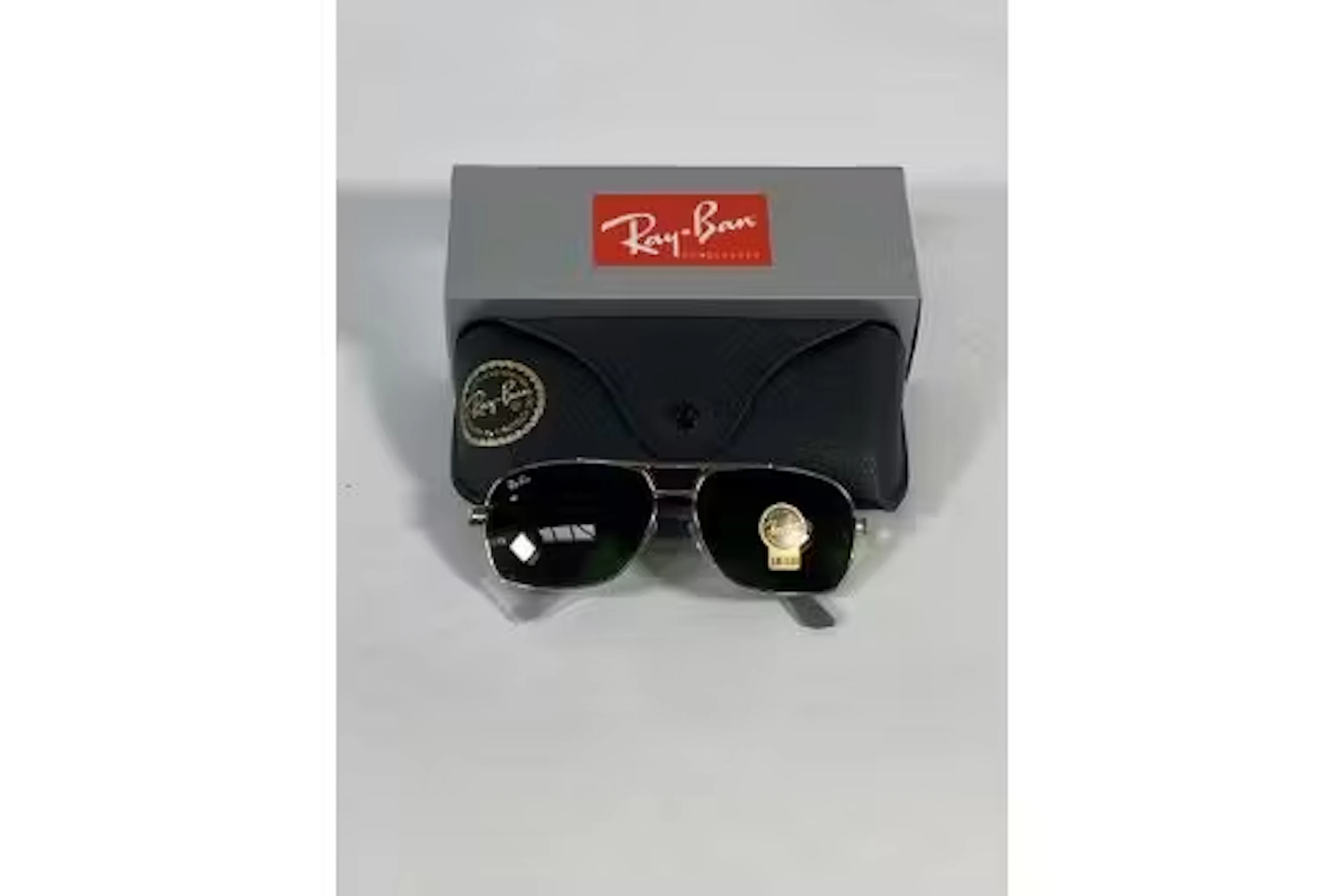 A pair of Ray-Bans Square sunglasses in polished gold and black with