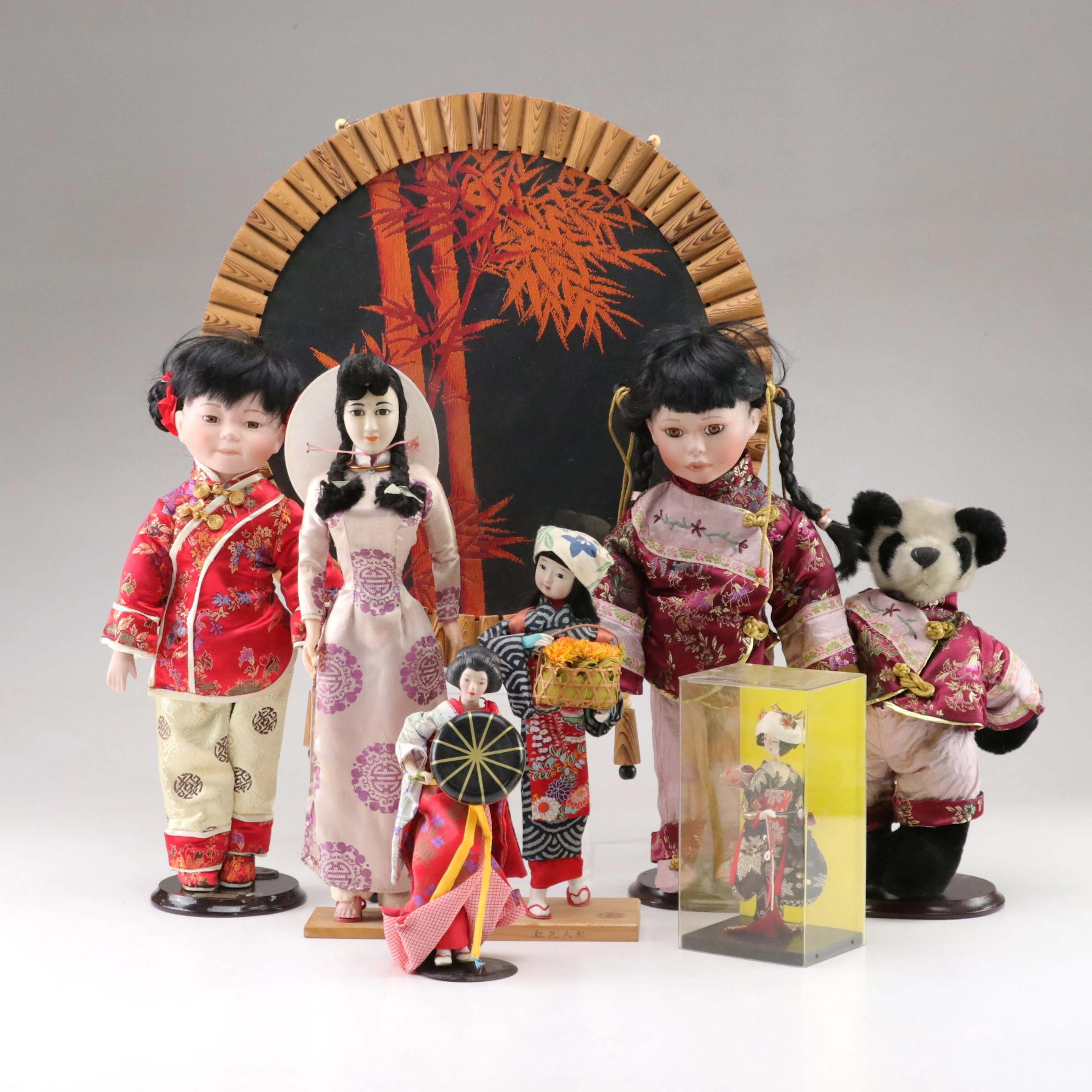 Collection of Various Porcelain Asian Dolls with Bamboo Themed Wall Hanging