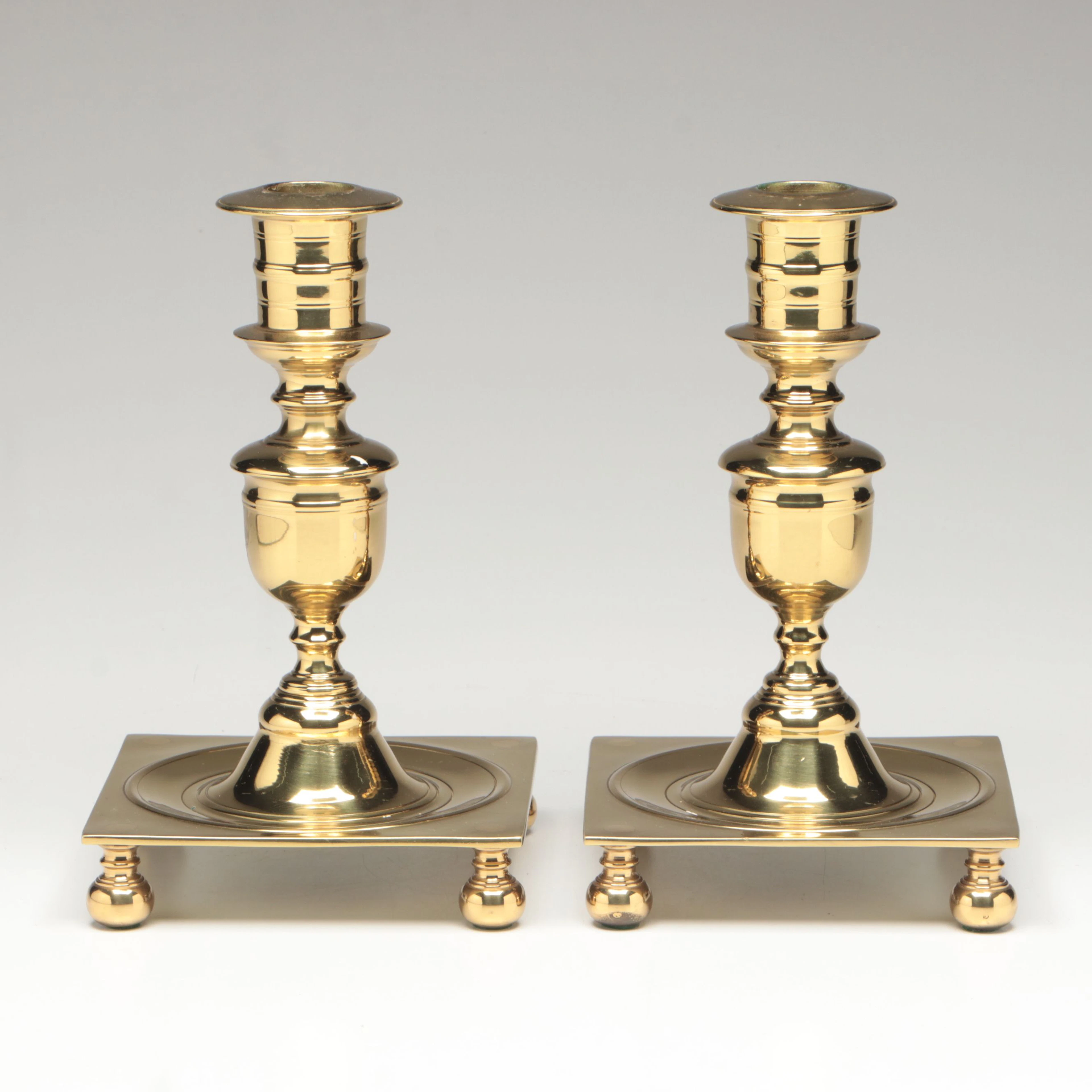 Pair of Virginia Metalcrafters "Newport" Polished Brass Footed Candlesticks