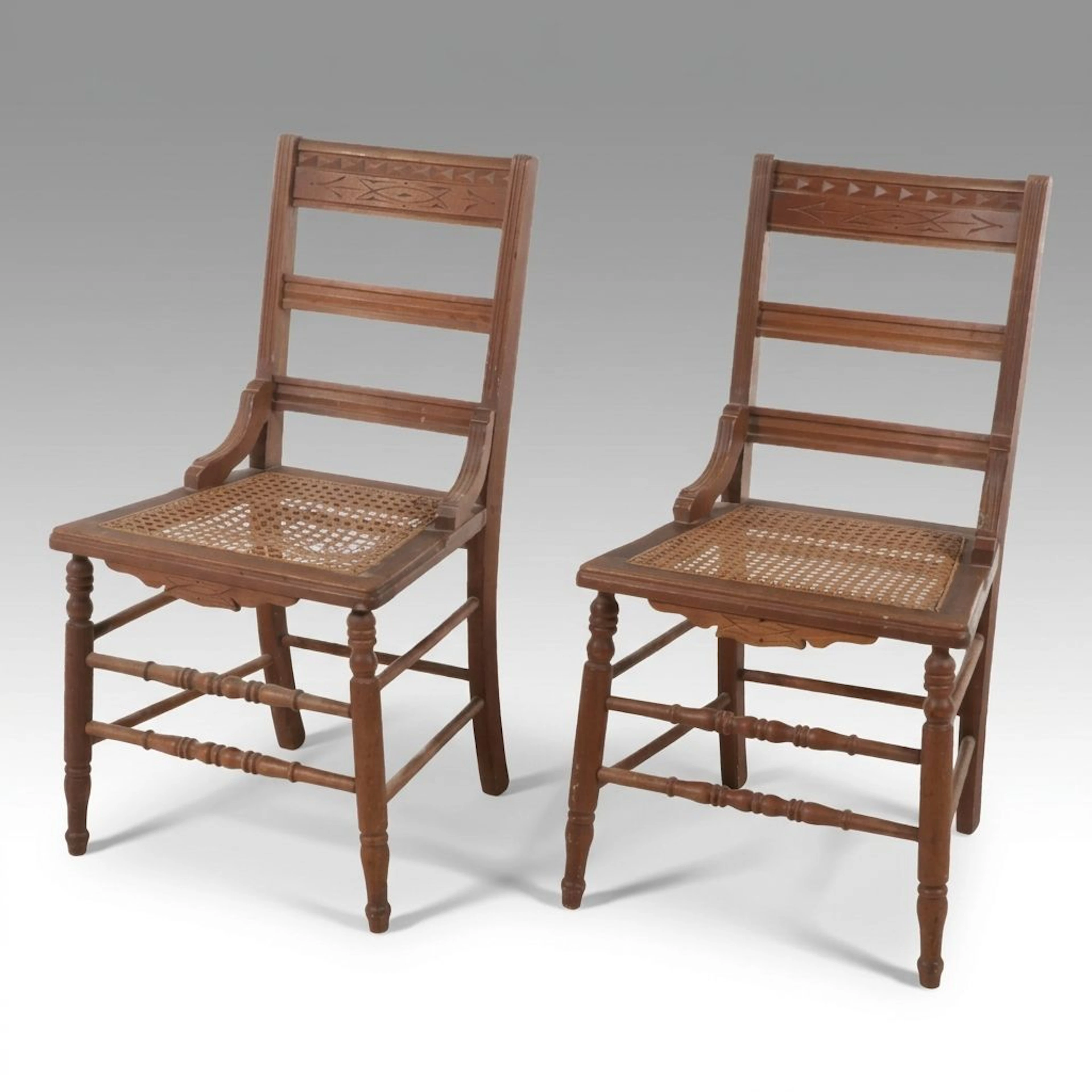 Pair of Eastlake Carved Walnut Side Chairs with Caned Seats