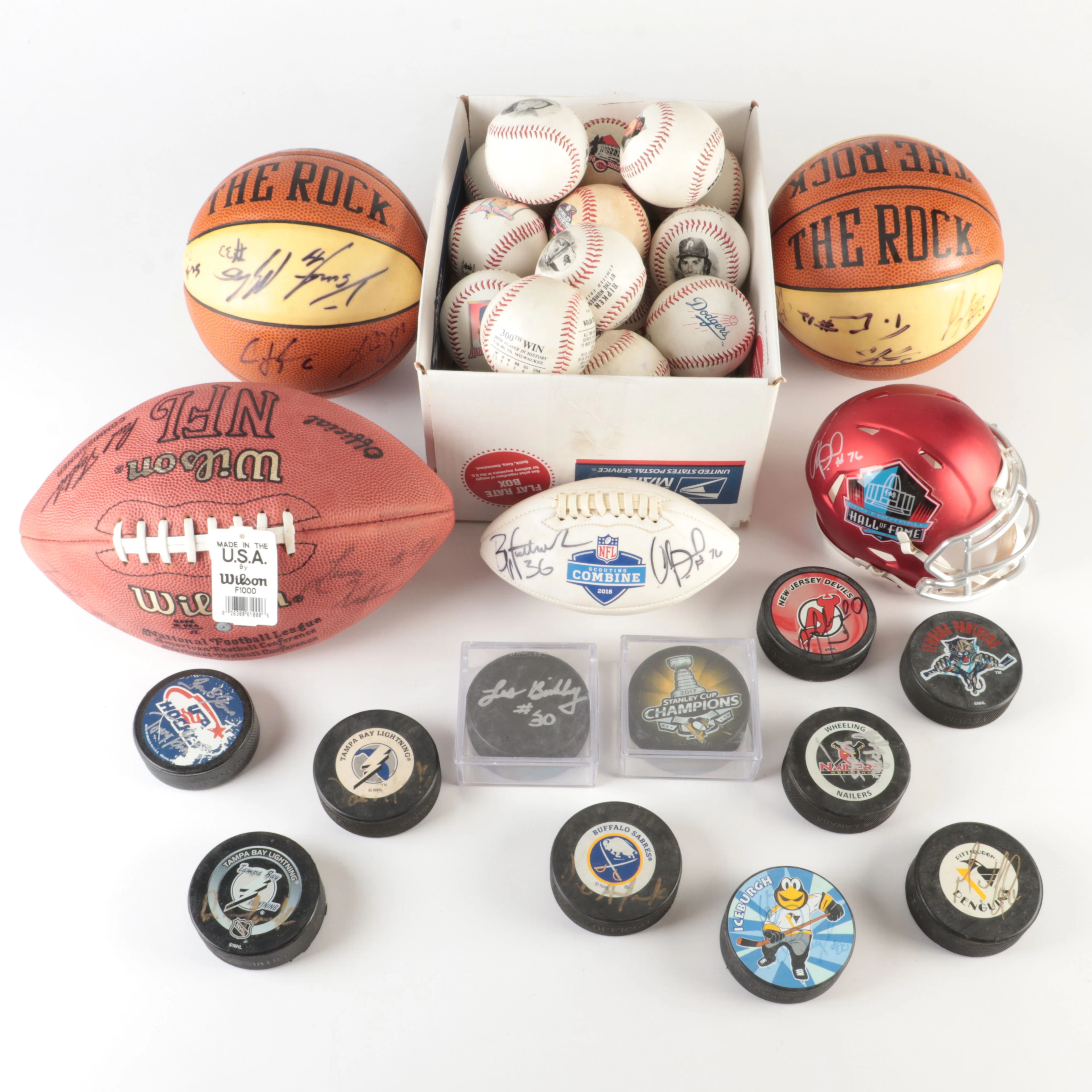 Collection off Signed Footballs, Hockey Pucks, Basketballs, and More