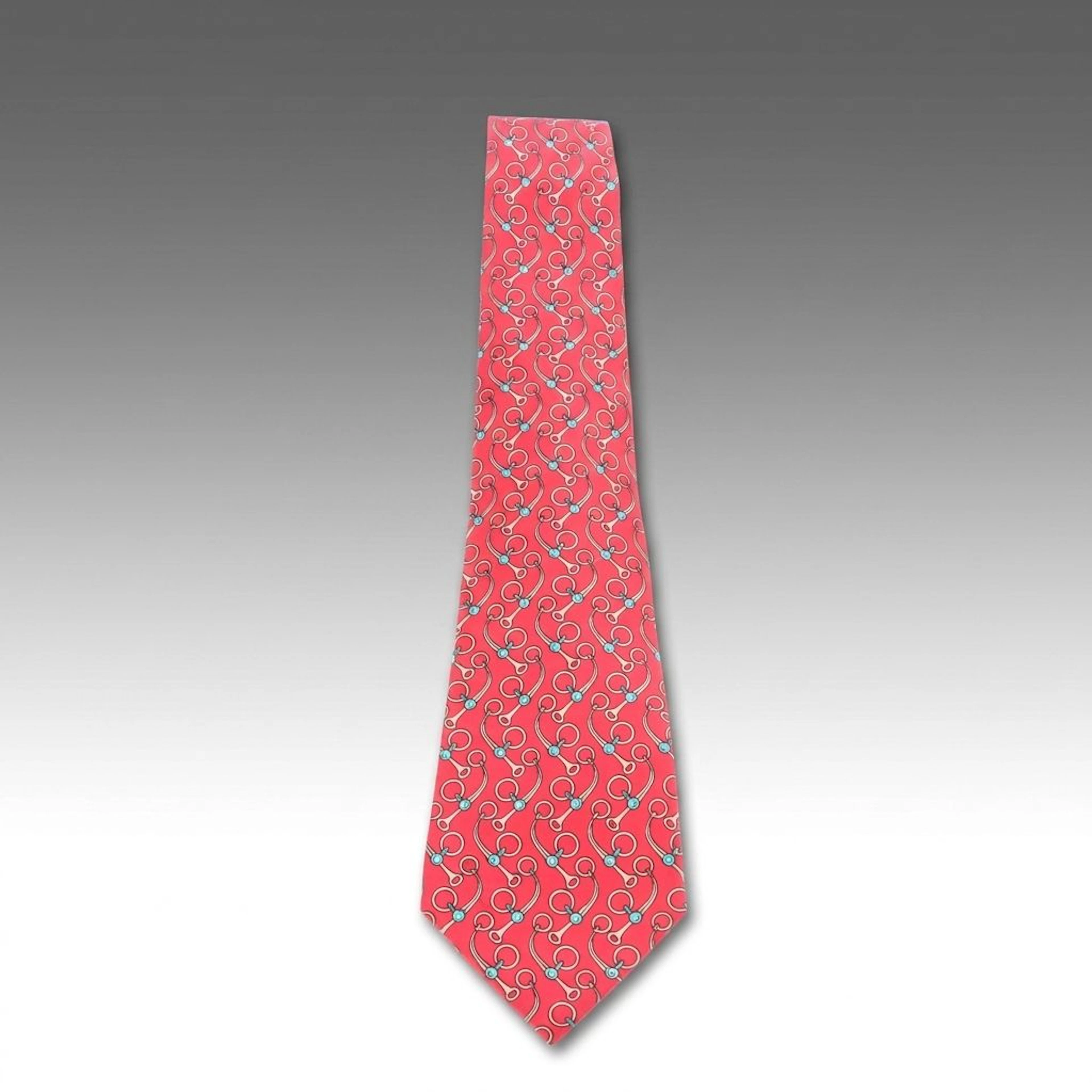 Hermés Silk Neck Tie in Turquoise and Cream Horsebits on Red Pattern