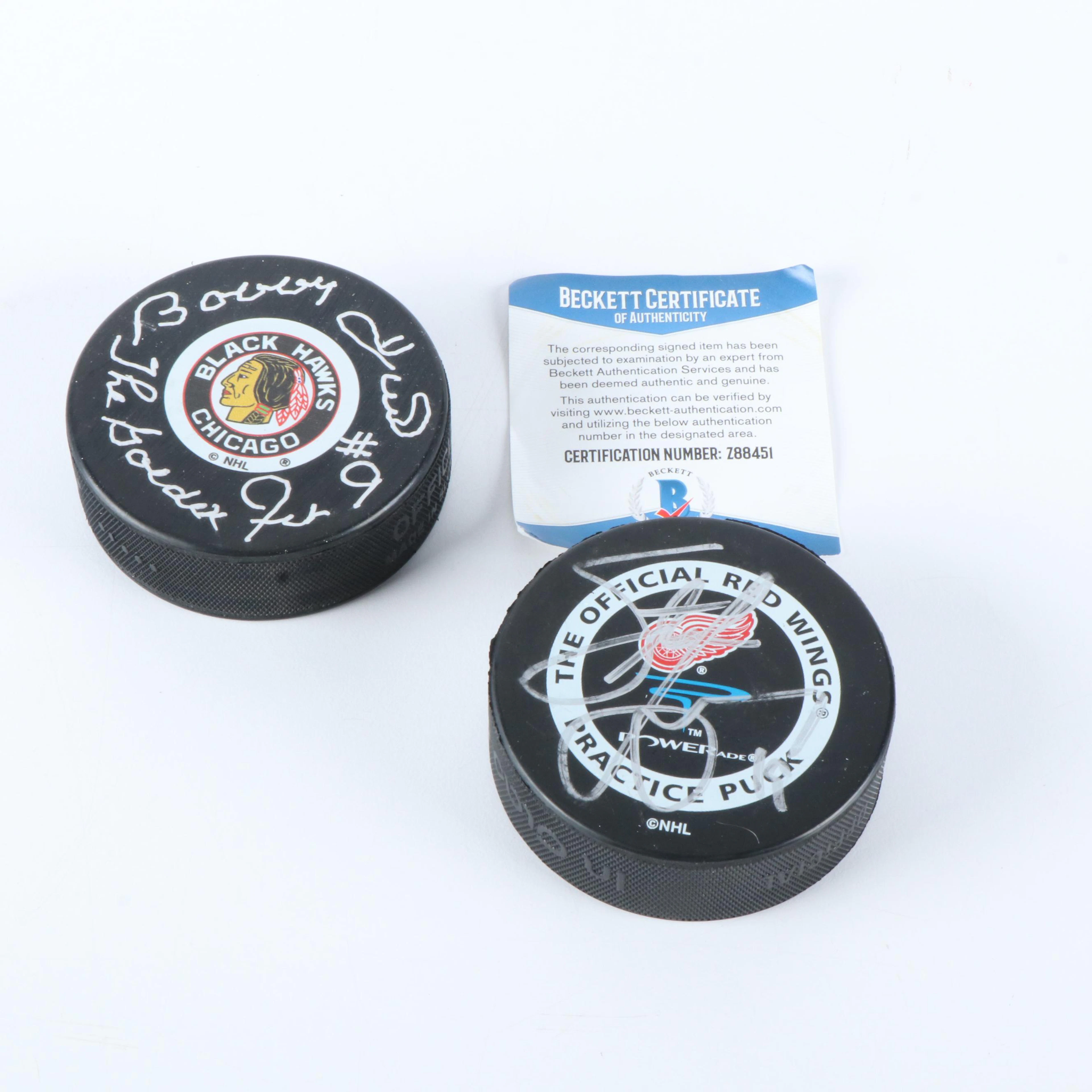 Bobby Hull and Steve Yzerman Signed NHL Hockey Pucks, Beckett