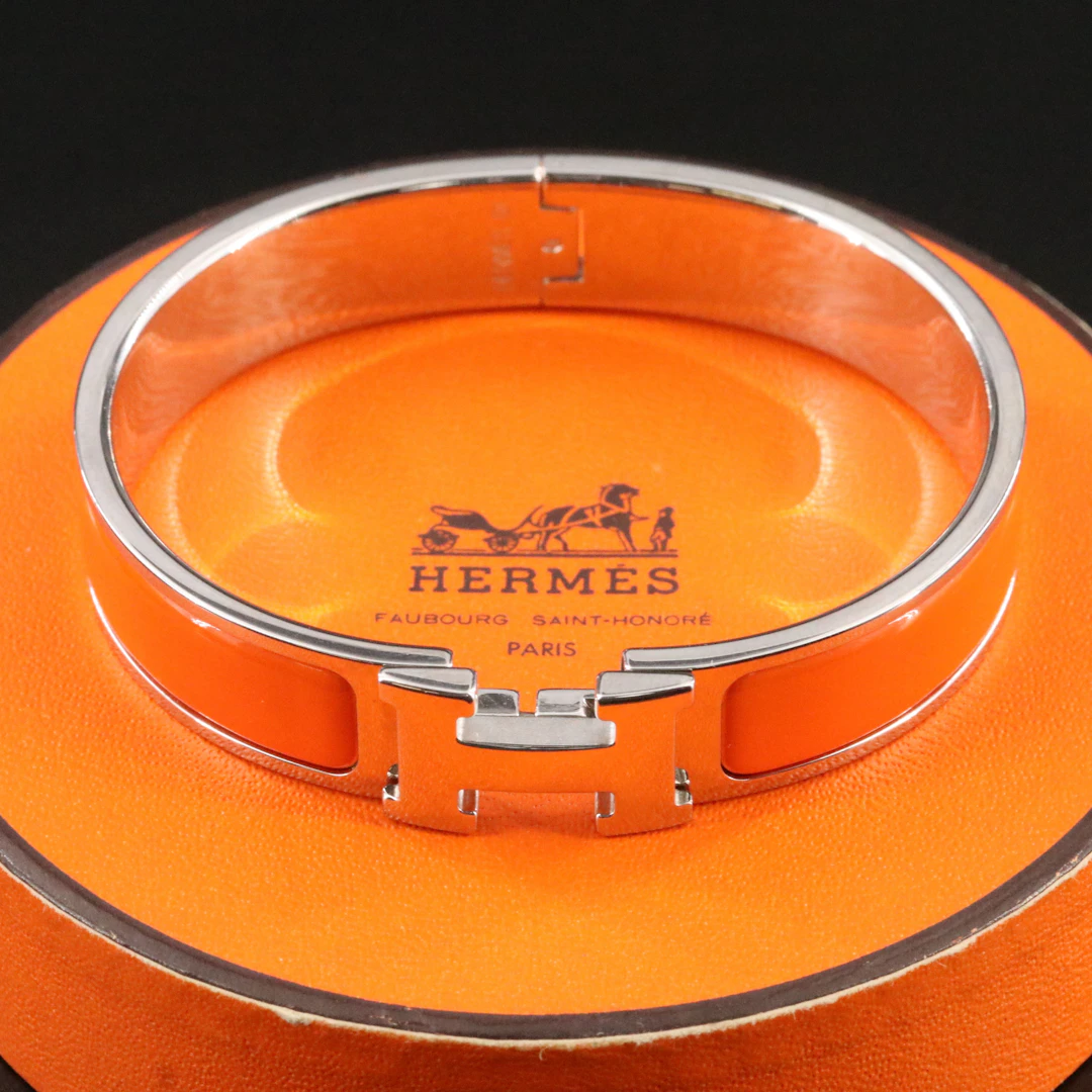 Hermès Clic H Silvertone and Orange Enamel Bracelet