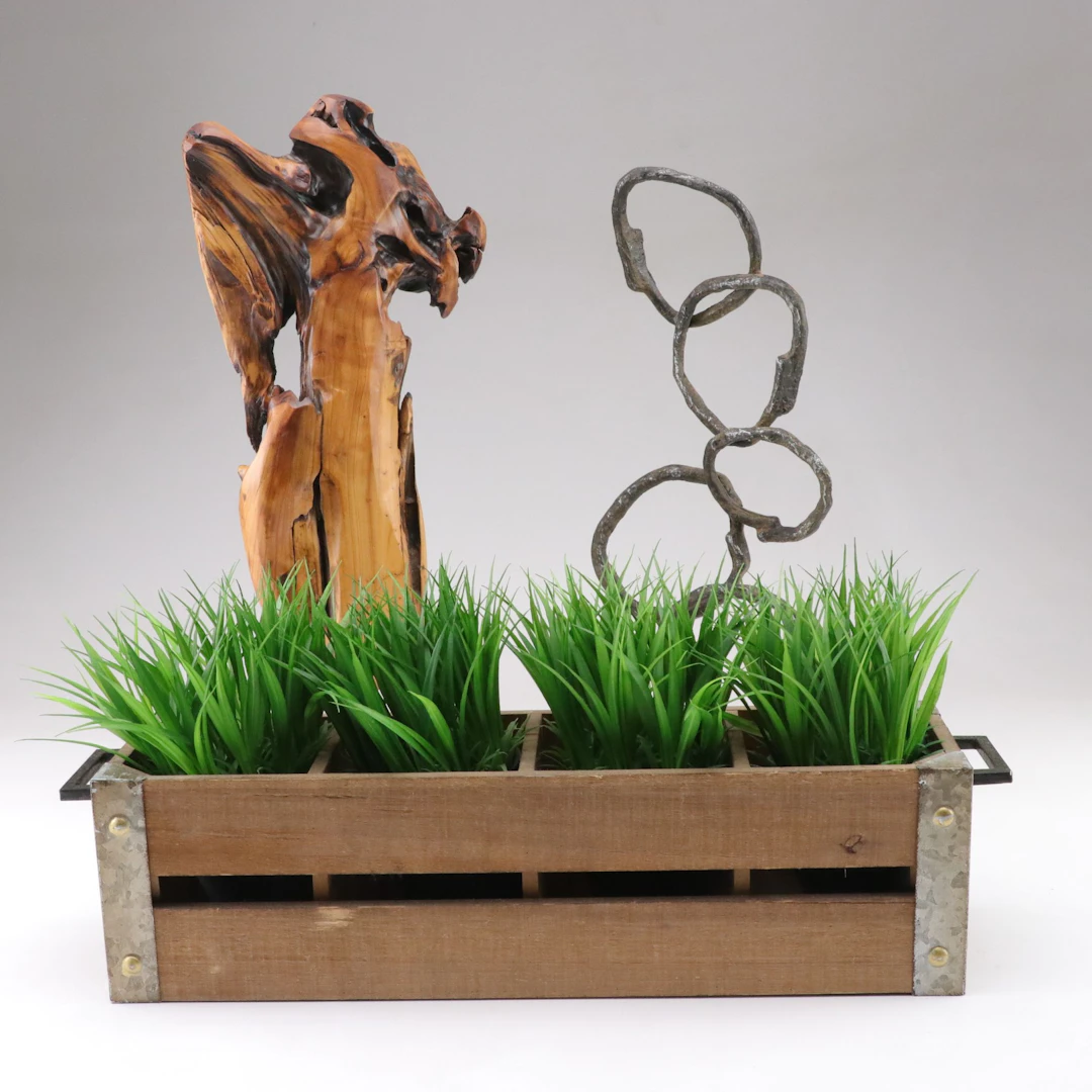Black Metal Rings Sculpture with Wood Sculpture and Faux Plants in Planter Box