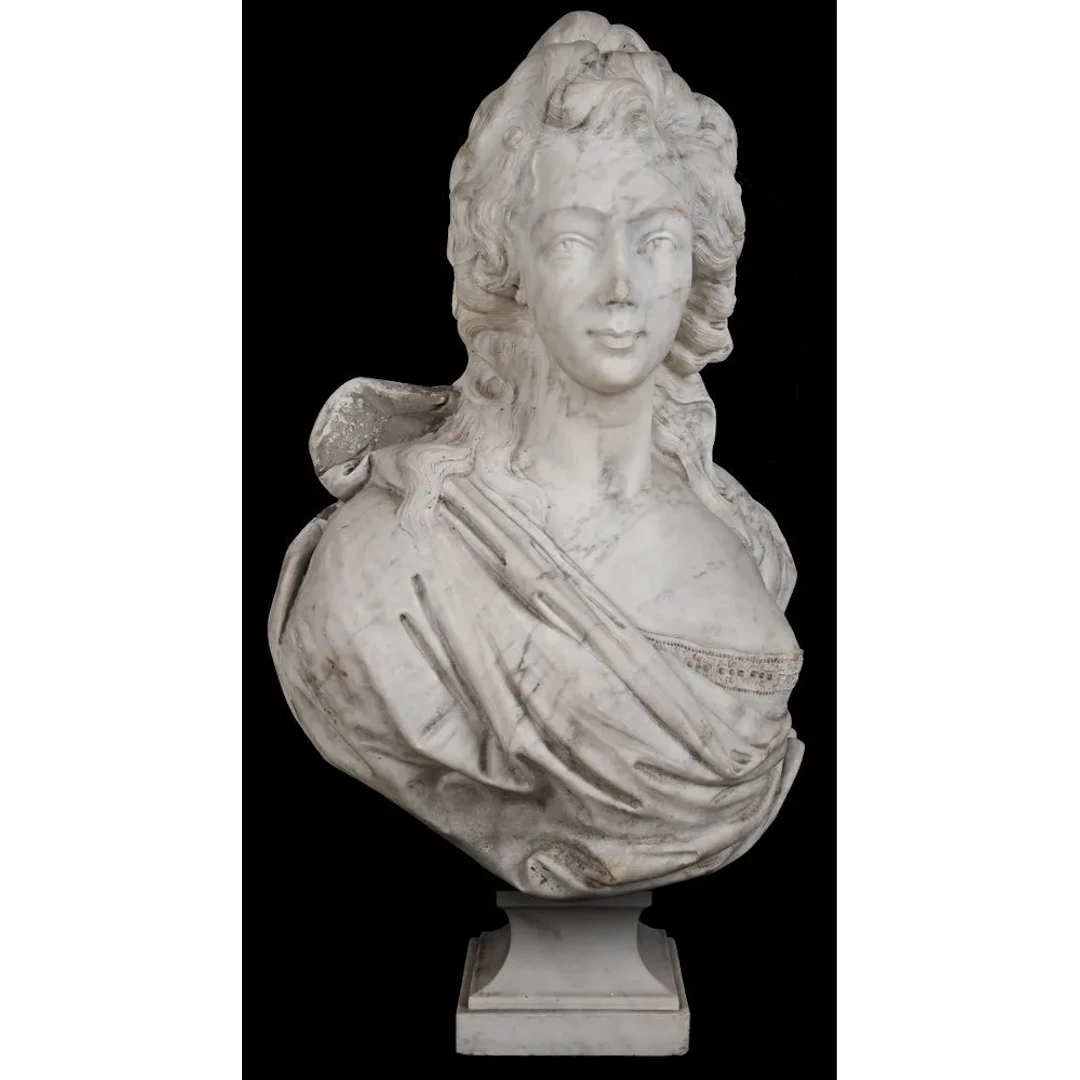 A marble sculpture, likely made of Carrara marble, depicting the bust