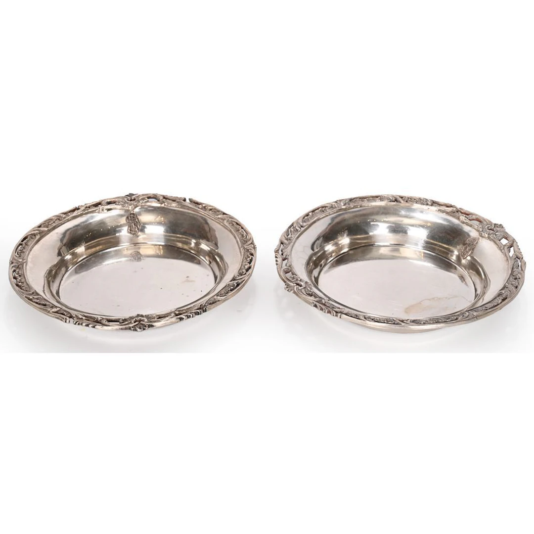 PAIR OF SILVER BOTTLE COASTS hallmarked with Minerva, featuring foliage