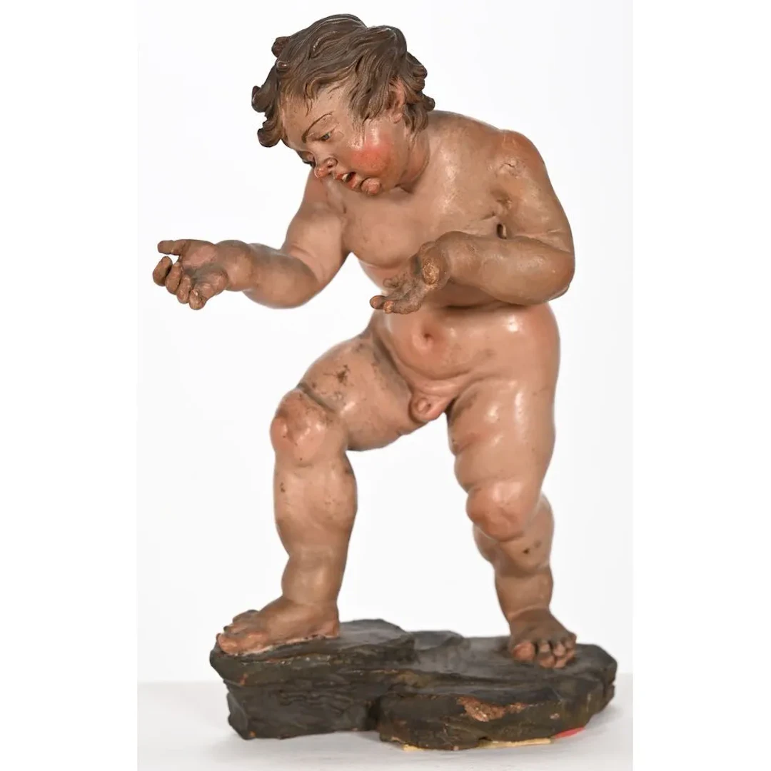 Polychrome terracotta figure depicting a nude cupid on a terrace