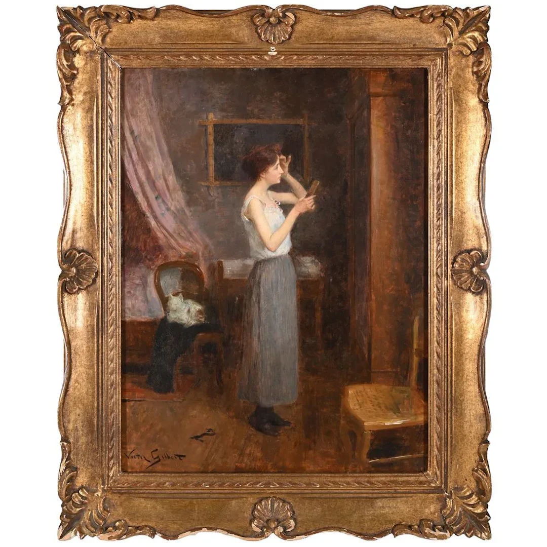 GILBERT, Victor. (1847–1935). “Woman Applying Makeup in an Interior.”