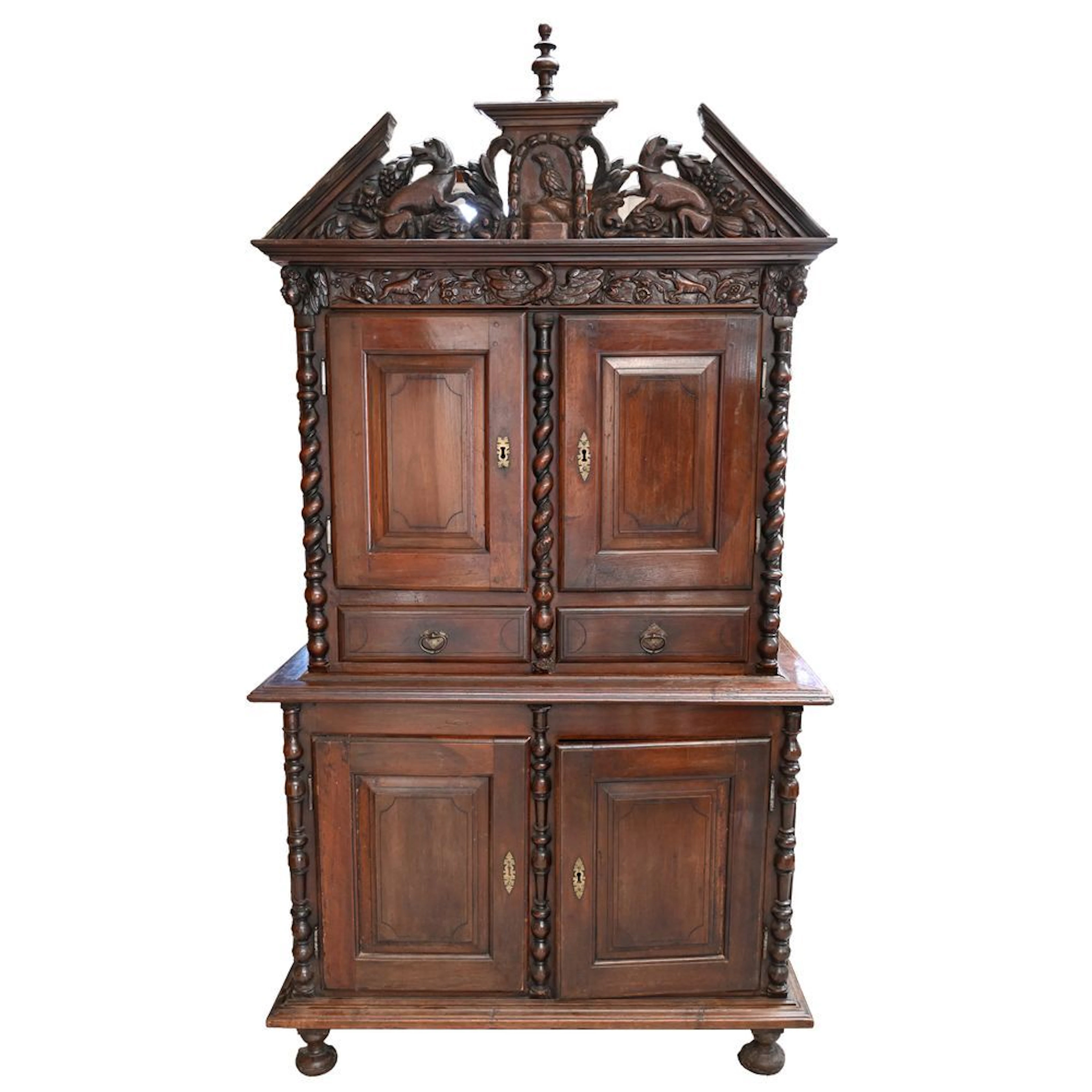 A TWO-PART LOUIS XIII CABINET in walnut with carved decorations of