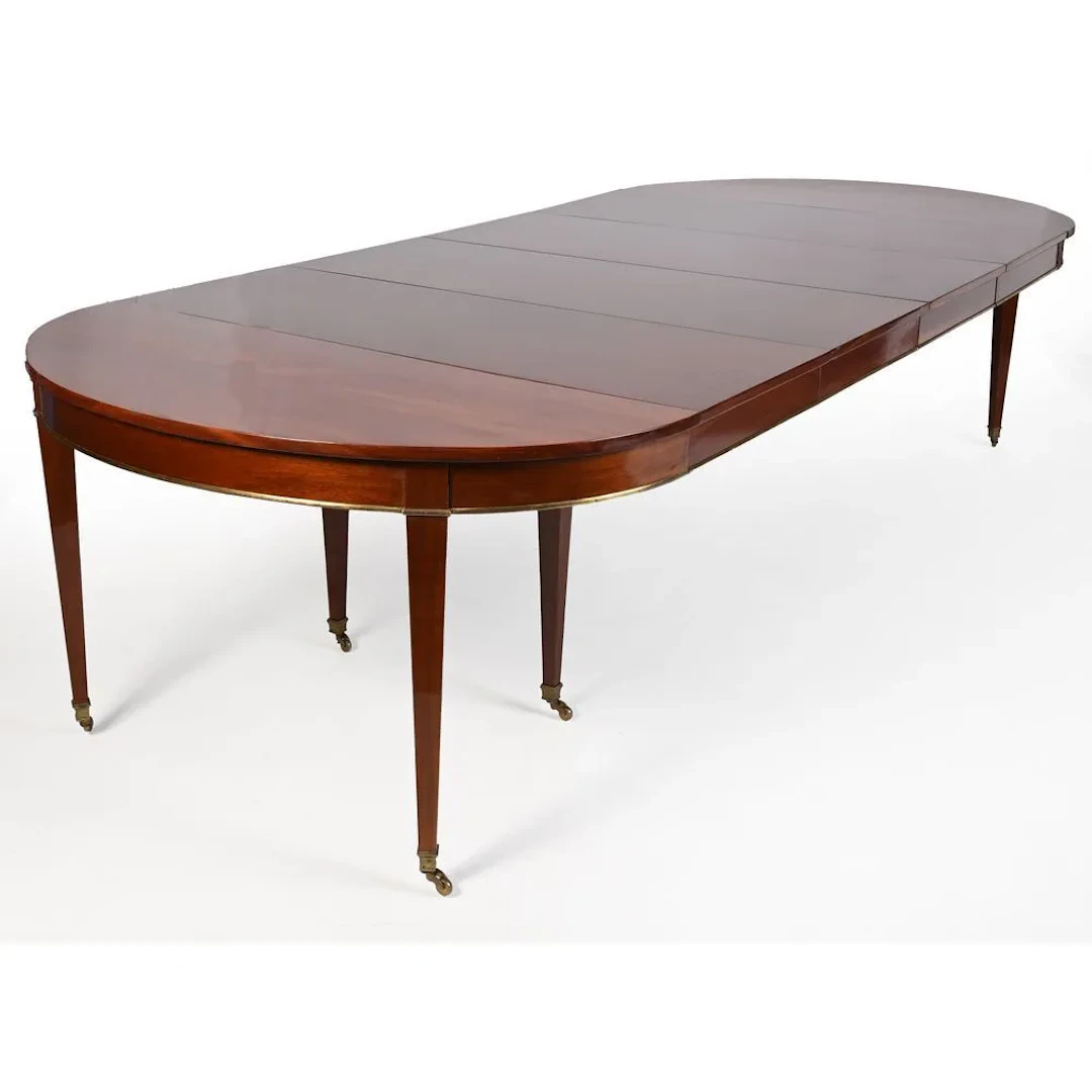 DIRECTOIRE-STYLE DINING TABLE in mahogany and mahogany veneer, featuring
