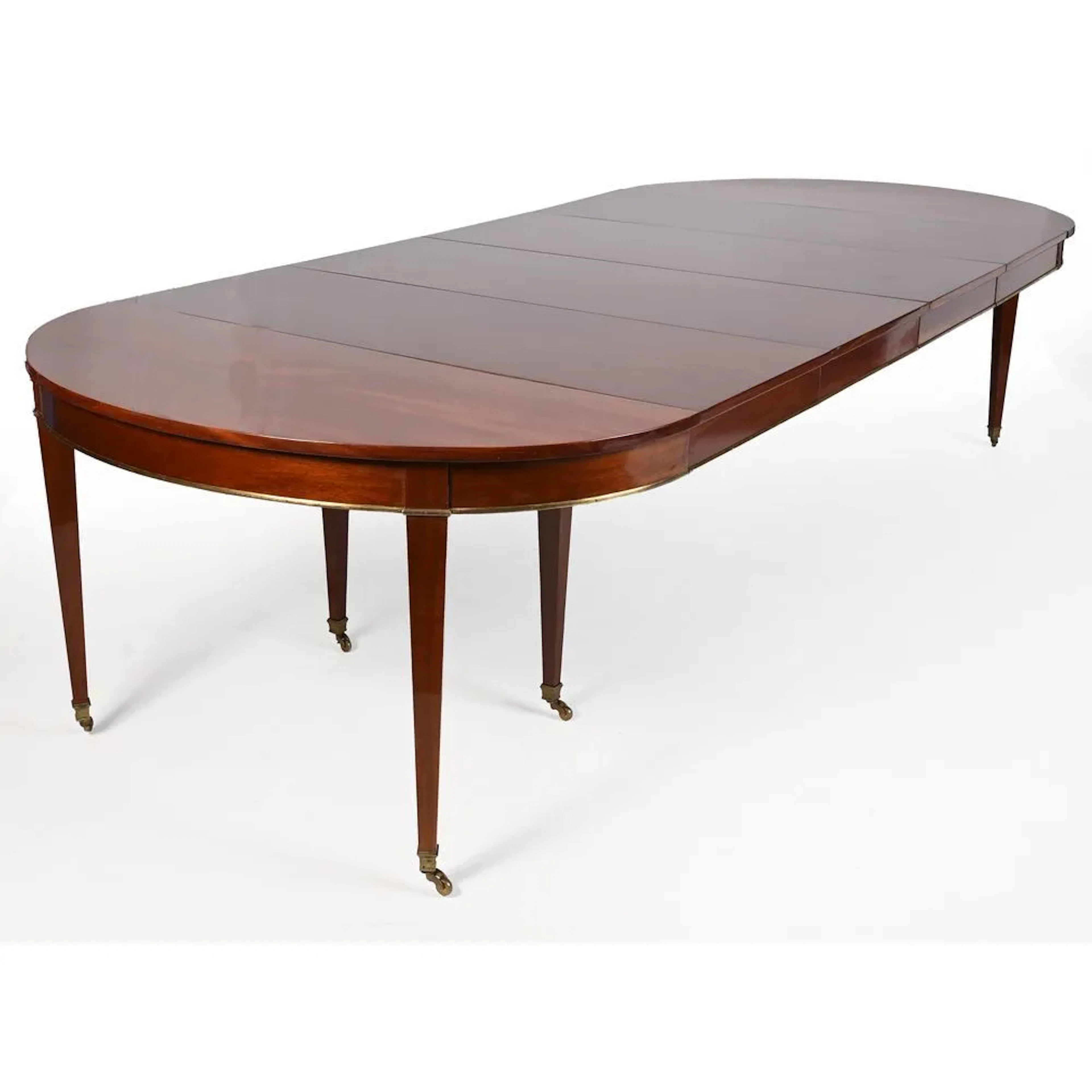 DIRECTOIRE-STYLE DINING TABLE in mahogany and mahogany veneer, featuring