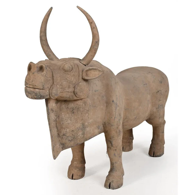 RARE AND IMPORTANT BOVINE FIGURE (part of a pair). Orange terracotta.