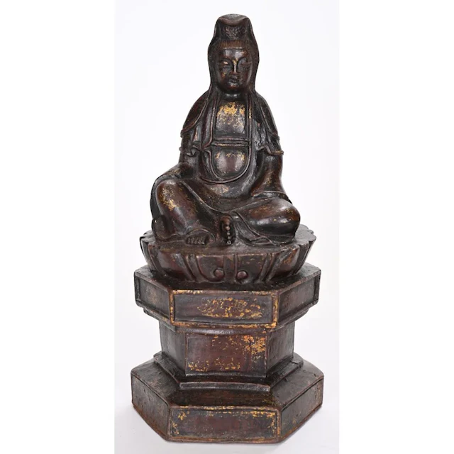 SMALL GUANYIN made of cast iron with traces of old gilding. Bears