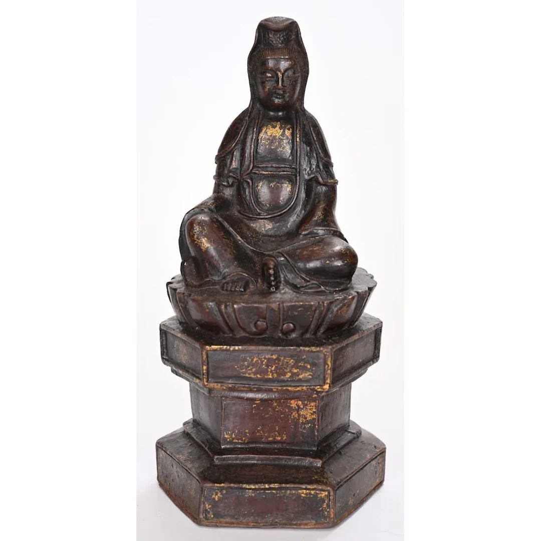SMALL GUANYIN made of cast iron with traces of old gilding. Bears