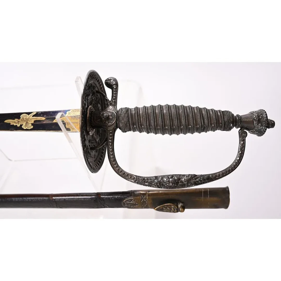 Sword with a silver-plated bronze hilt. Blued blade with various decorations.