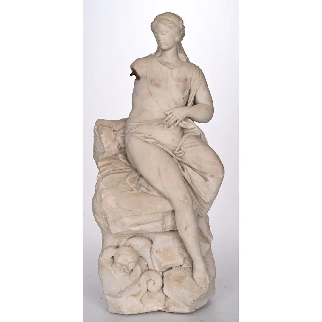 Marble SCULPTURE GROUP depicting Venus seated on a rocky outcrop.