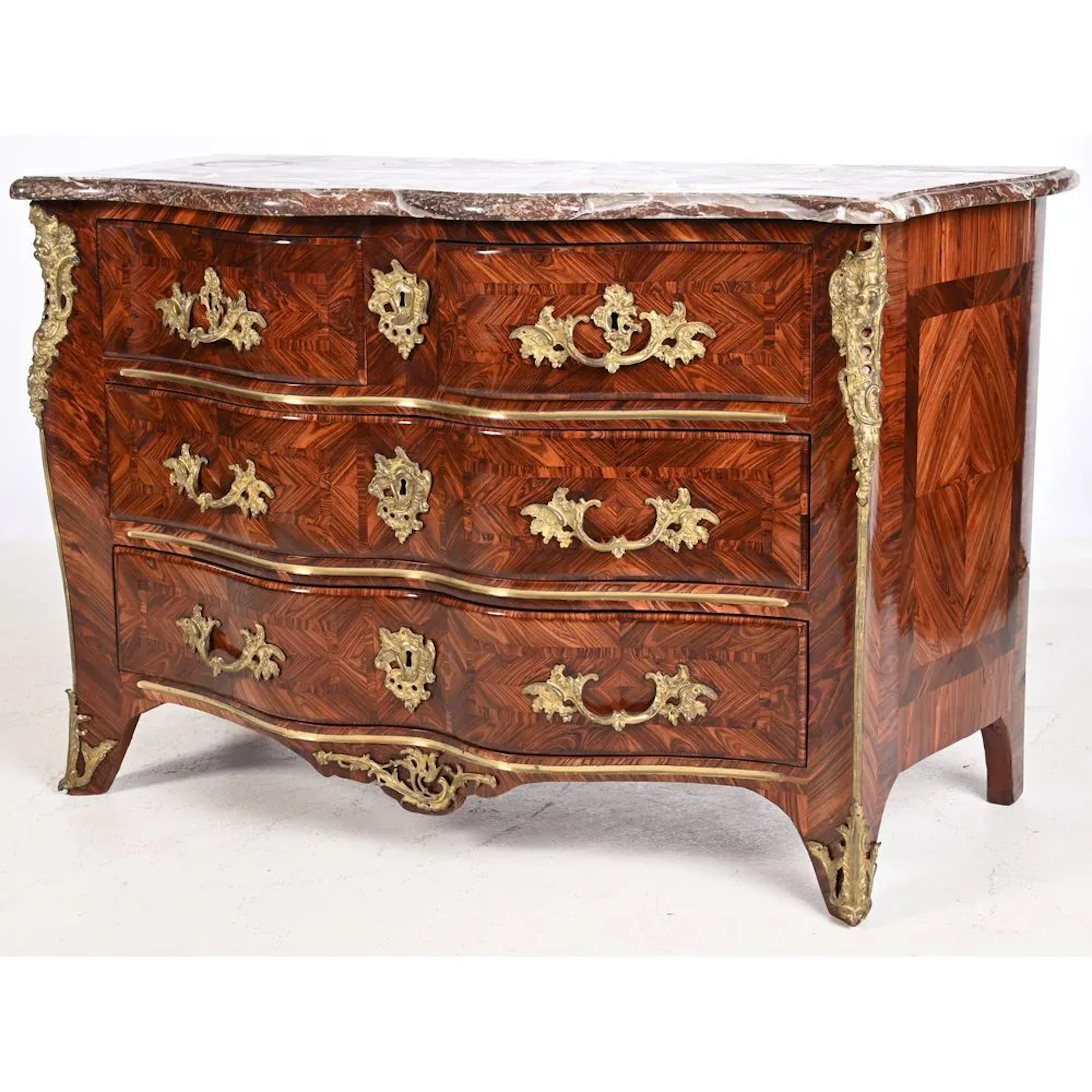 REGENCE CHEST OF DRAWERS with a crossbow-style front, entirely in