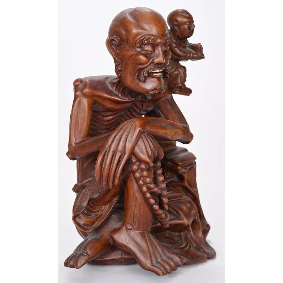 CURIOUS FIGURINE carved from exotic hardwood, depicting a skeletal