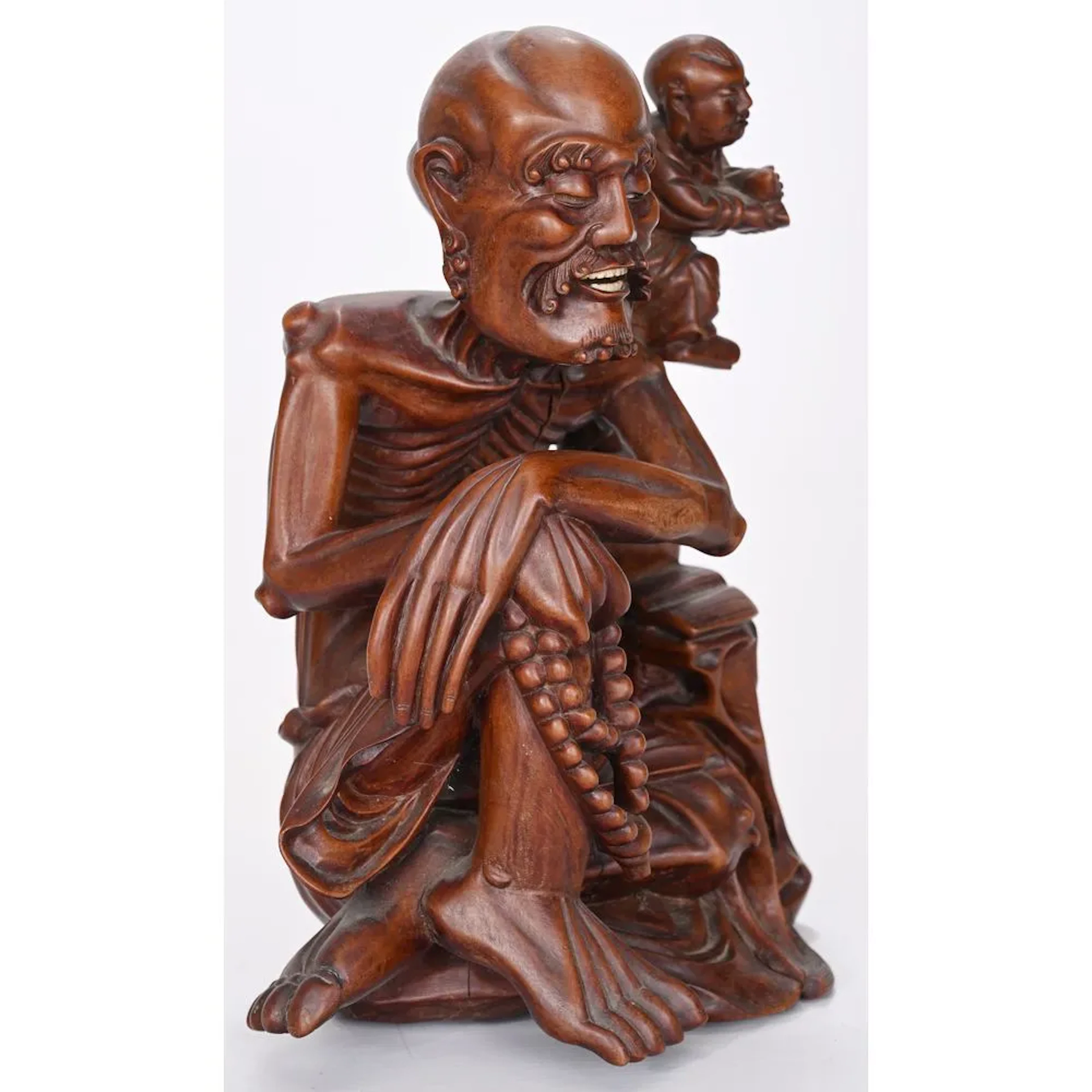 CURIOUS FIGURINE carved from exotic hardwood, depicting a skeletal