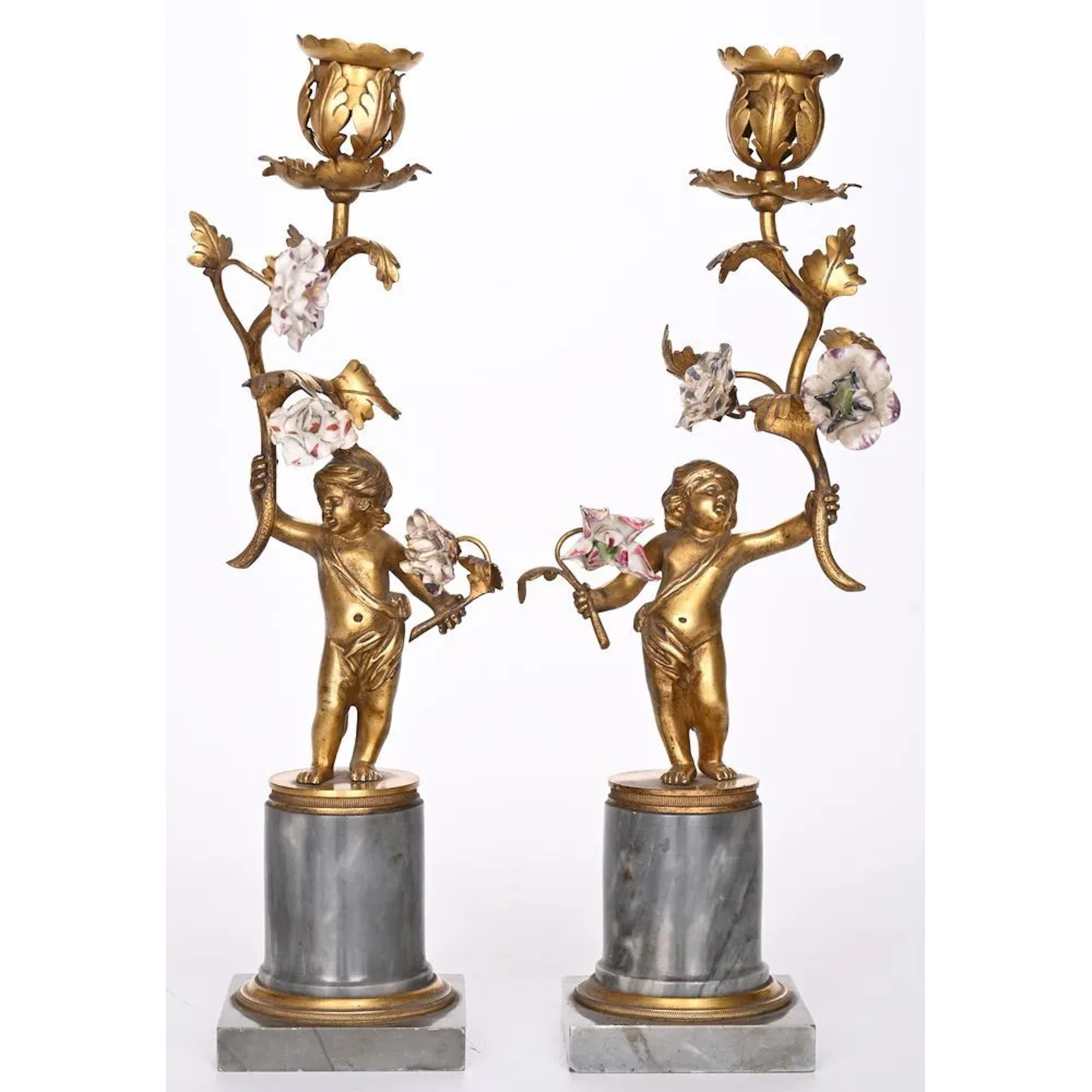 PAIR OF LOUIS XVI CANDLESTICKS in gilded bronze depicting a cupid