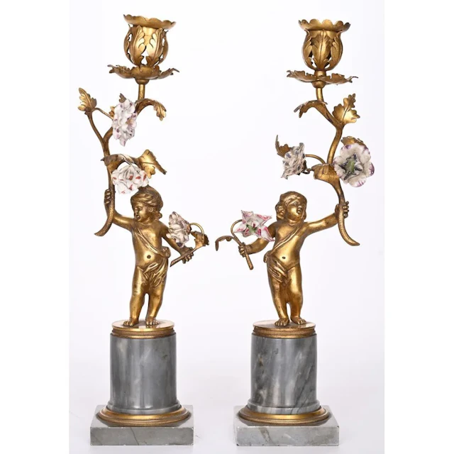 PAIR OF LOUIS XVI CANDLESTICKS in gilded bronze depicting a cupid