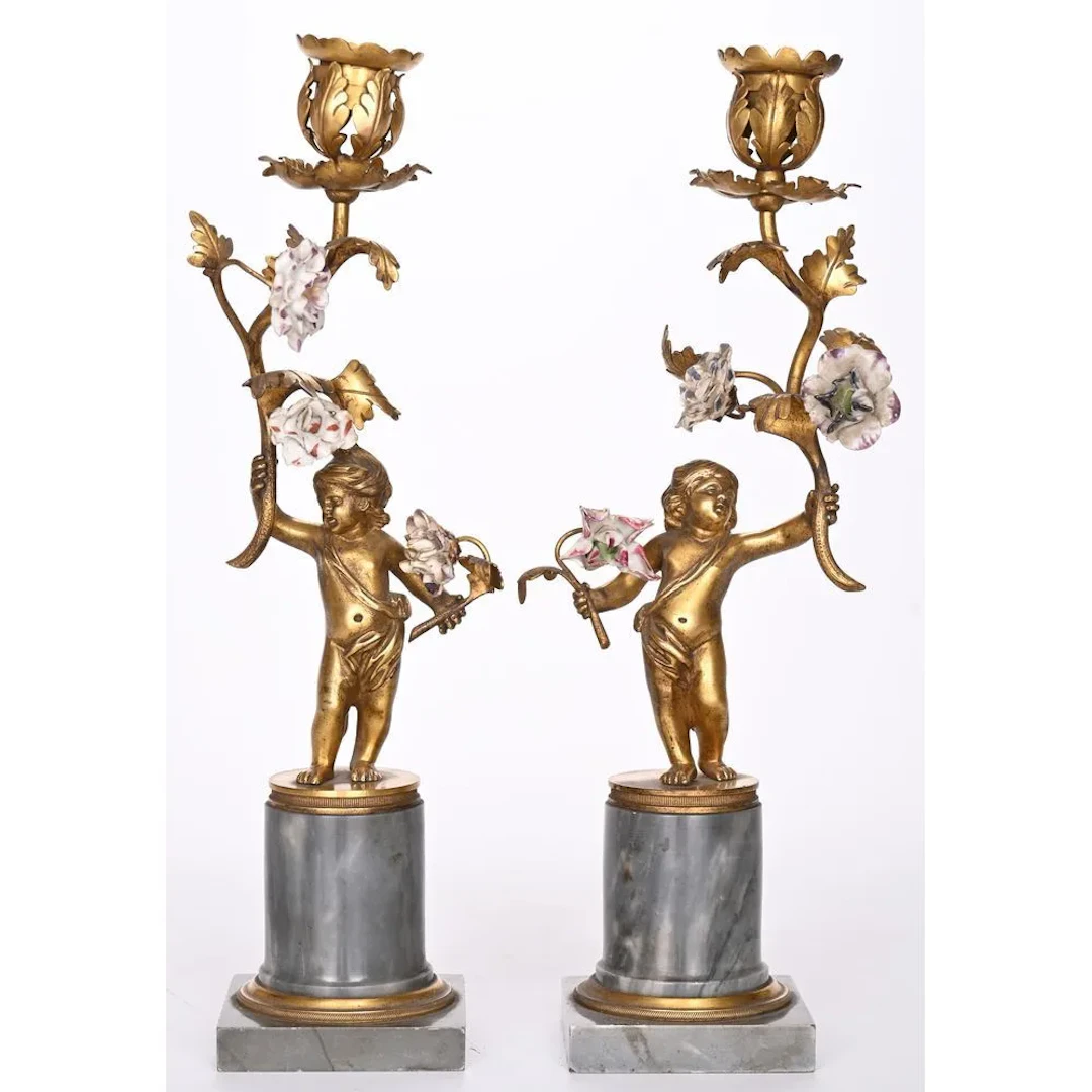 PAIR OF LOUIS XVI CANDLESTICKS in gilded bronze depicting a cupid