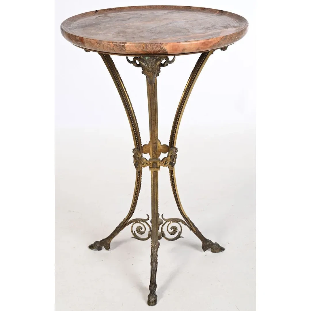 Bronze side table with a golden patina, featuring ram’s heads supporting
