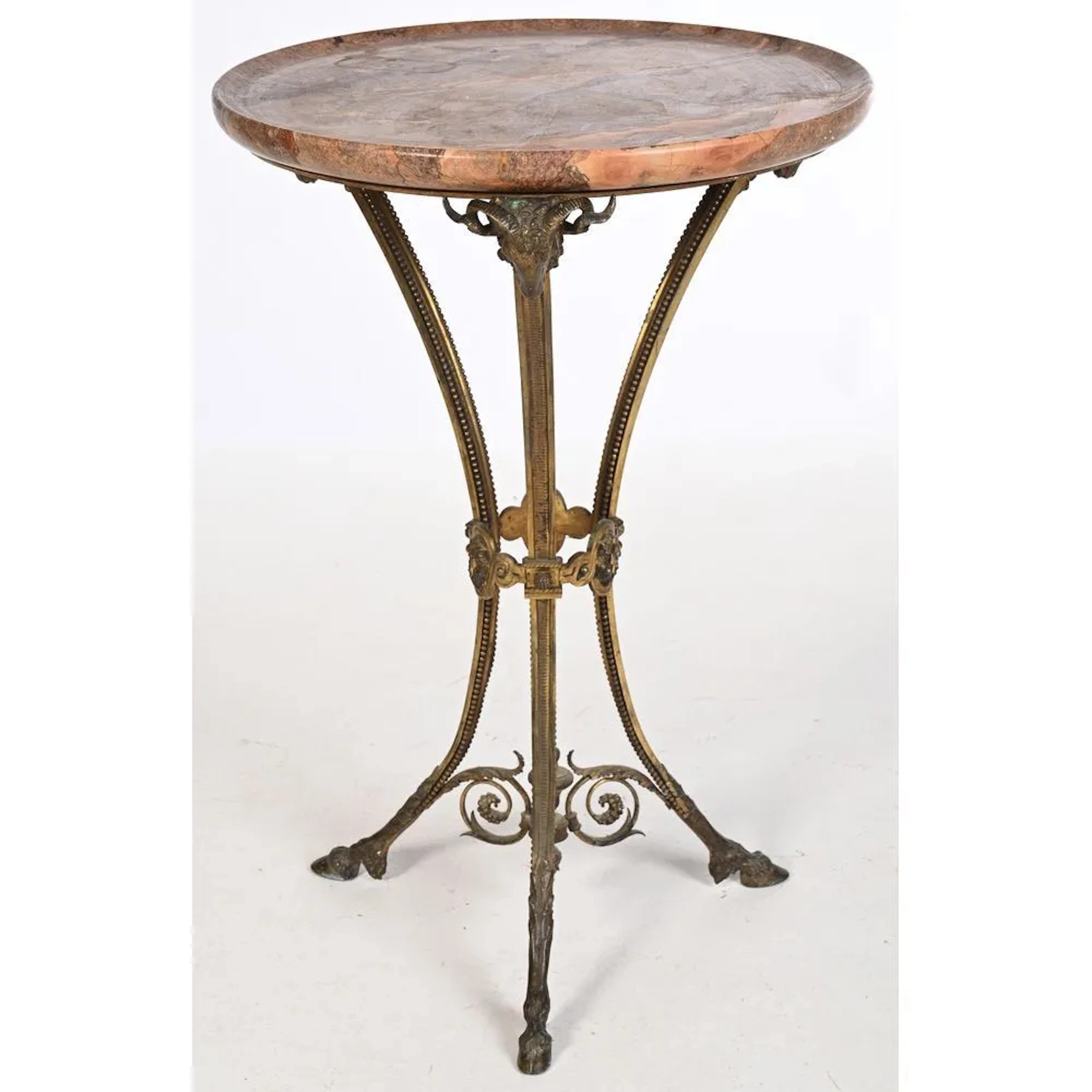 Bronze side table with a golden patina, featuring ram’s heads supporting