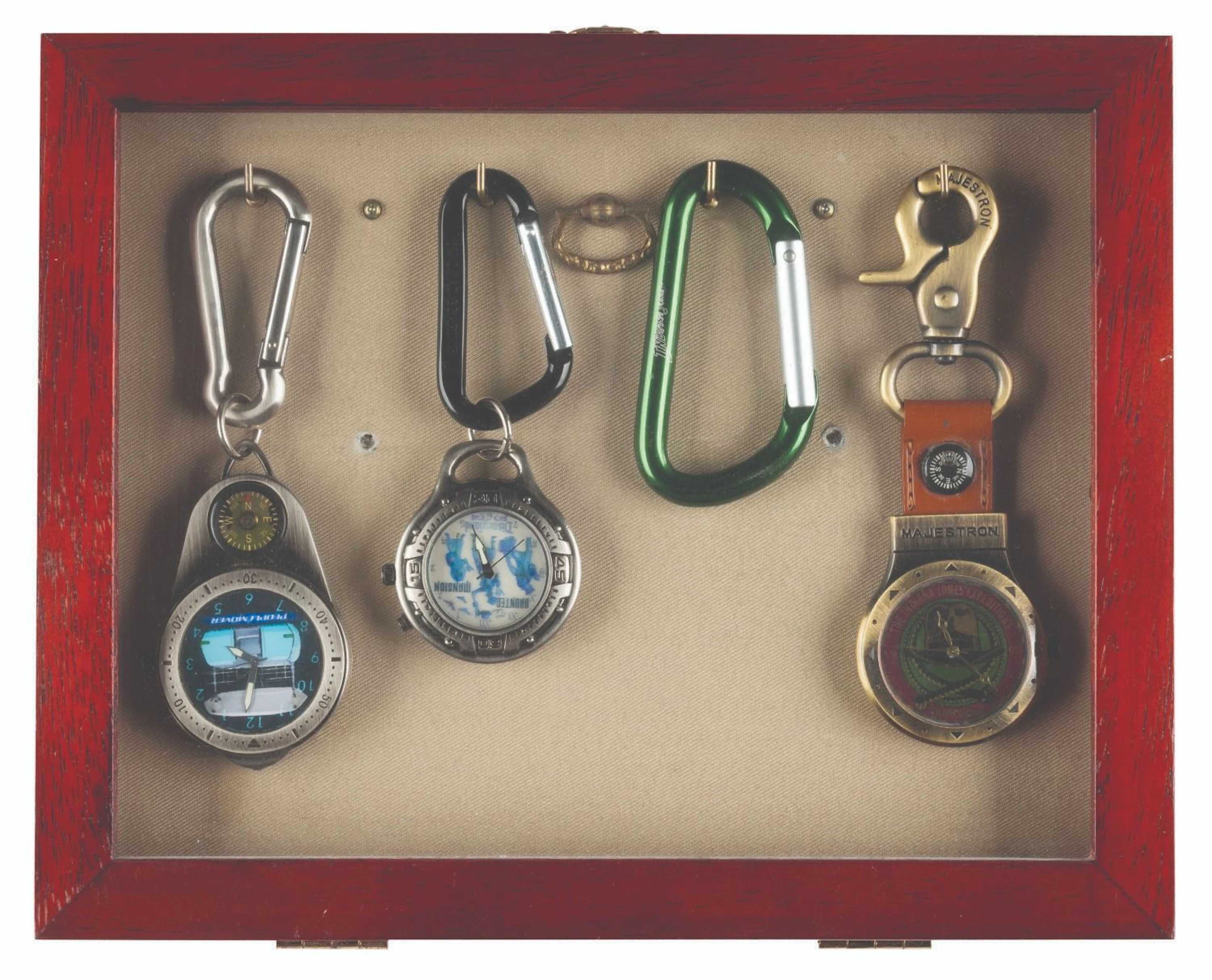 A Framed Collection of Attraction Watches and Carabiner.