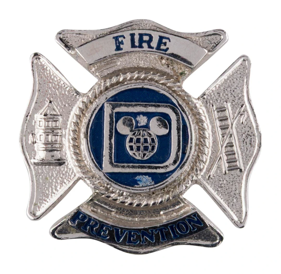 A Disney Fire Prevention Hat Badge.