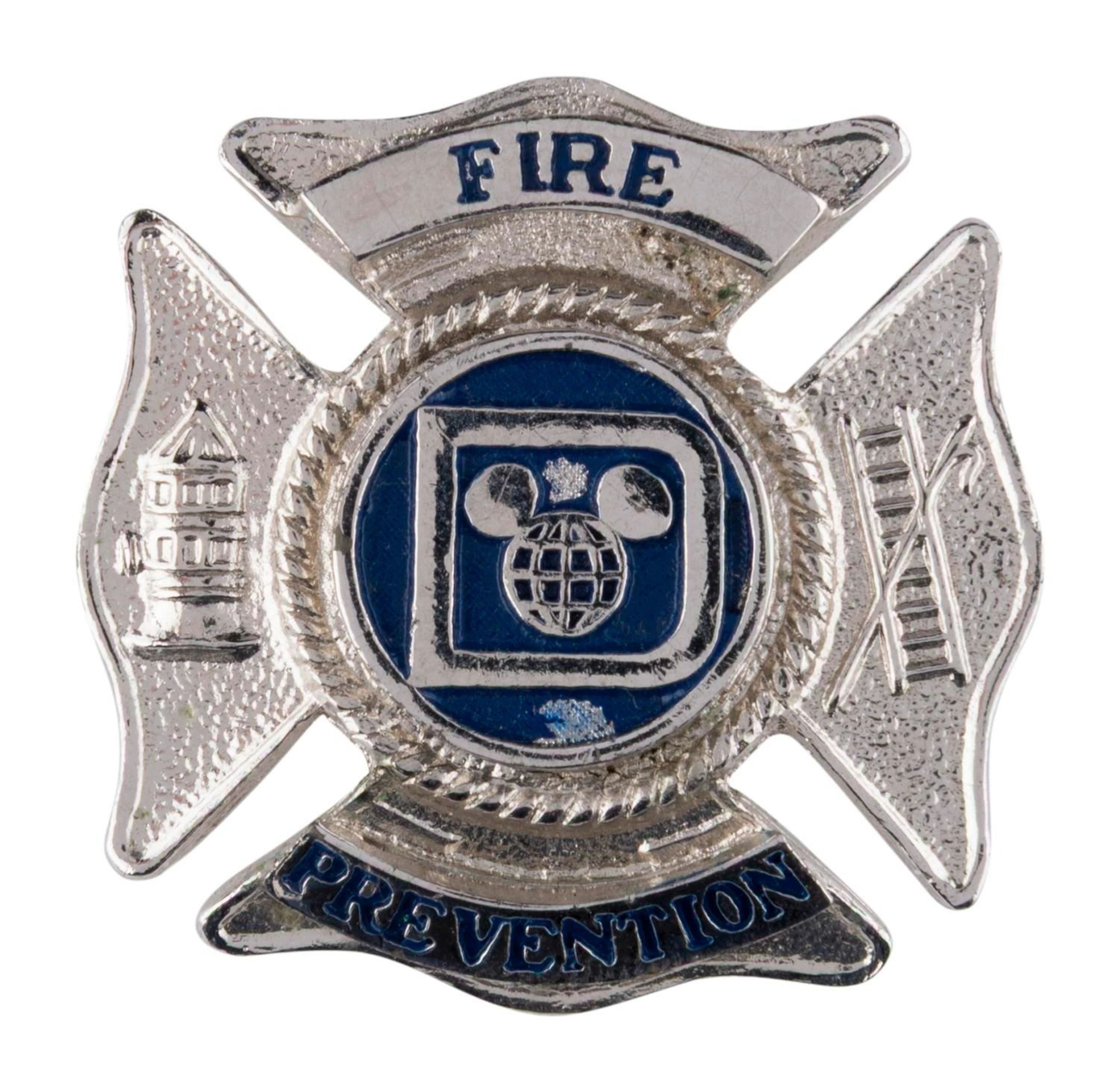 A Disney Fire Prevention Hat Badge.
