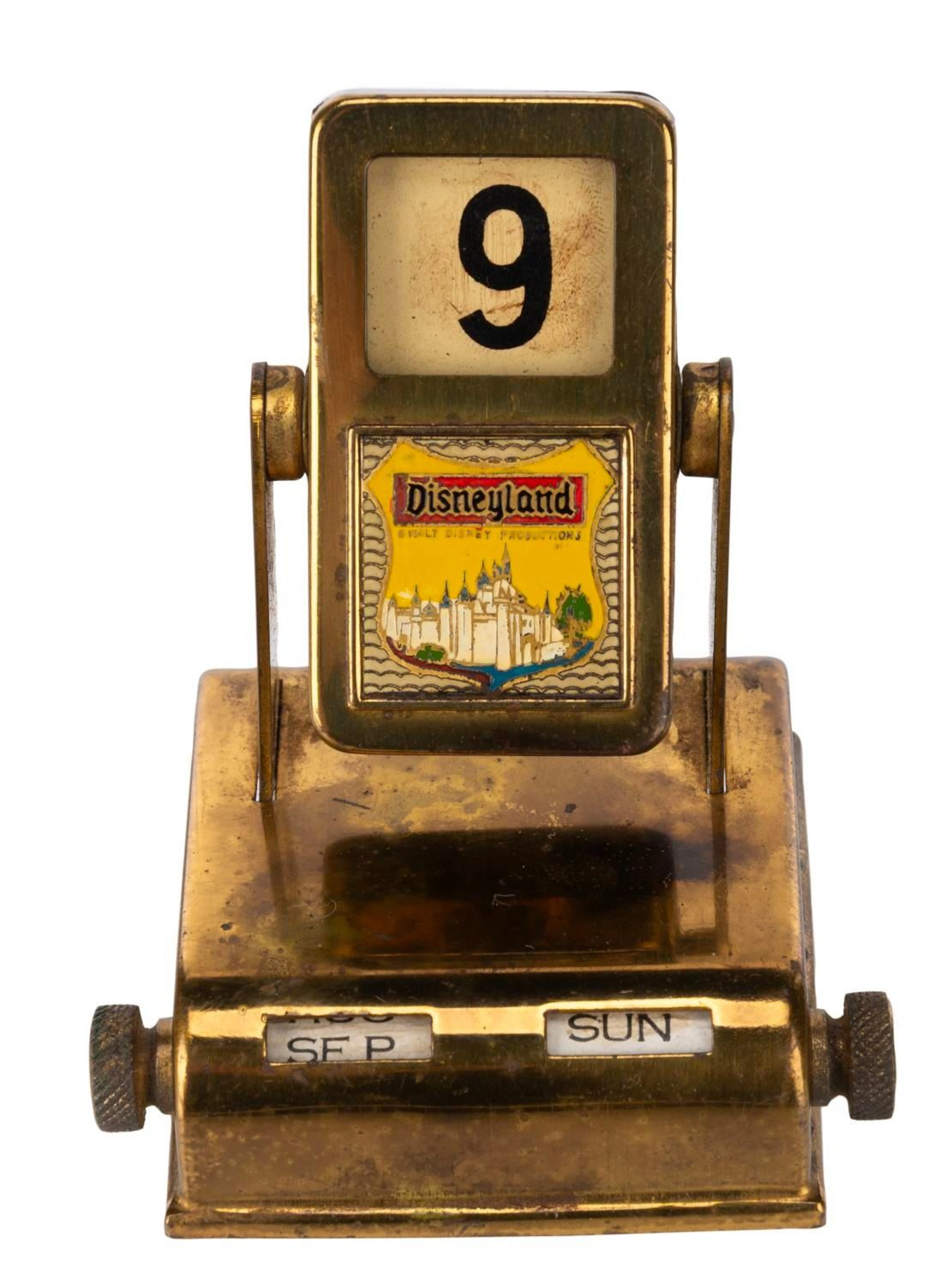 A Gold-Tone Disneyland Perpetual Calendar.