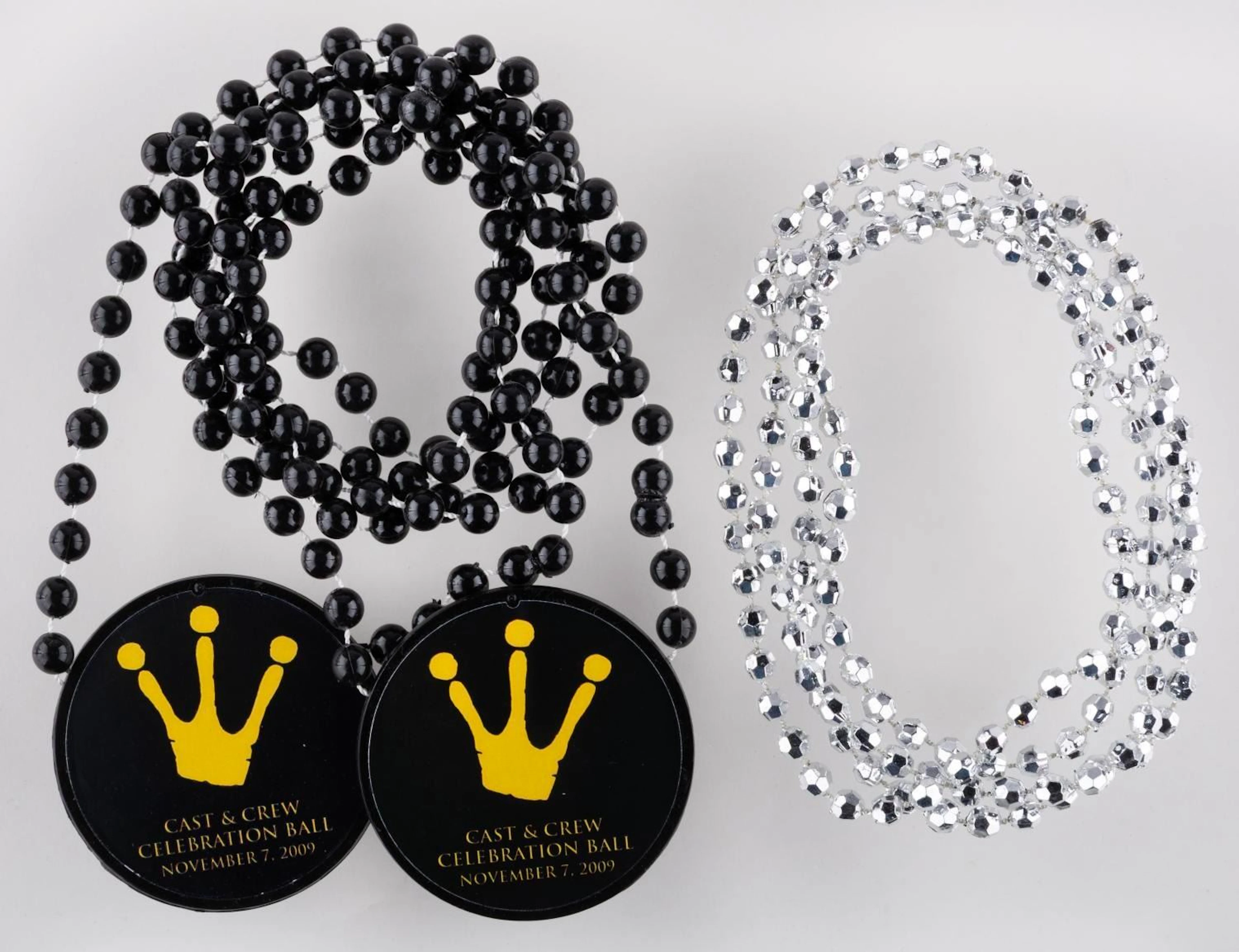 A Pair of "The Princess and the Frog" Crew Celebration Necklaces.