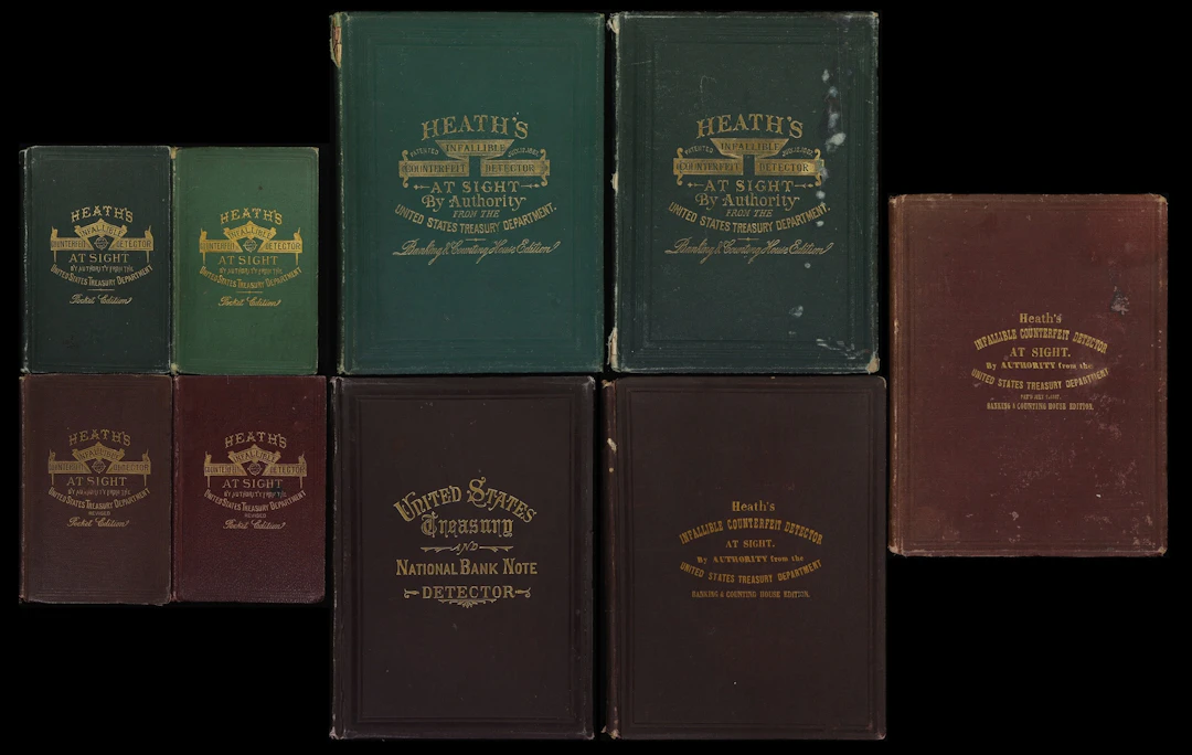 Lot of (9) Heath's Infallible Counterfeit Detector Books. 1860s-70s.
