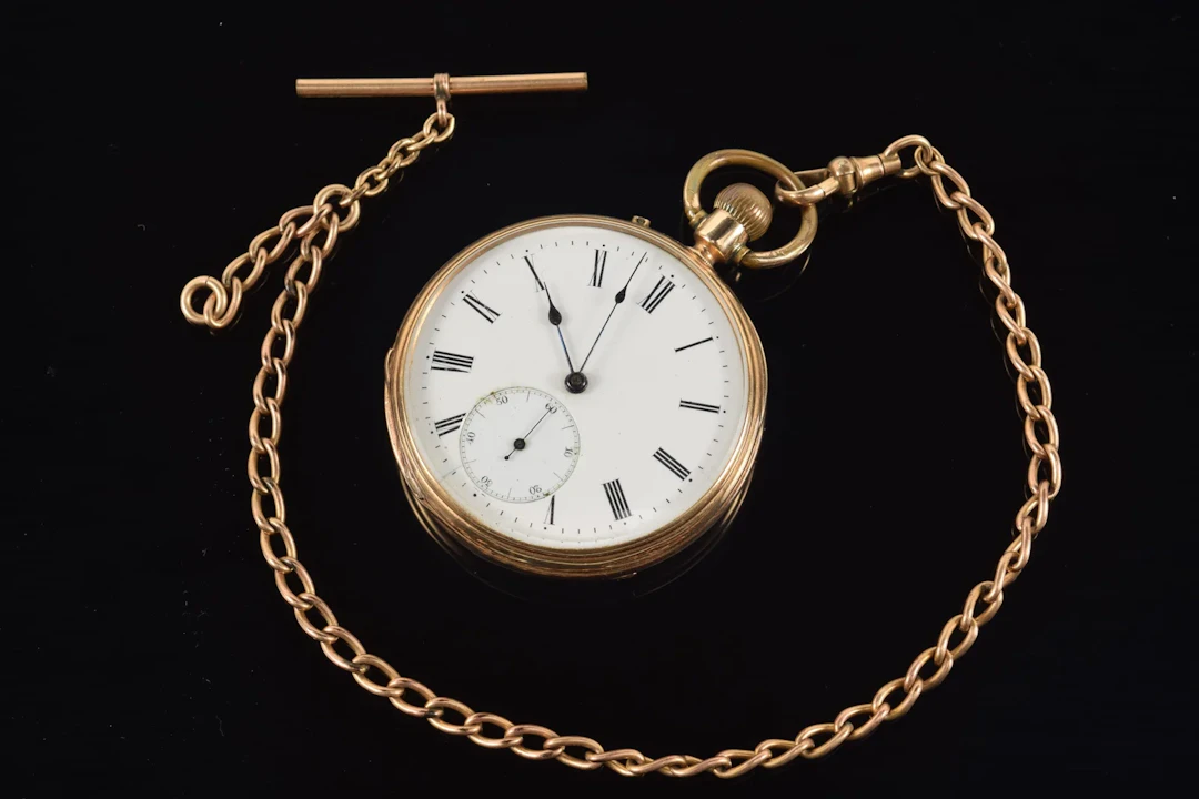 Antique 14K gold open face pocket watch with gold filled chain. Roman