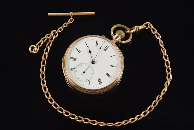 Antique 14K gold open face pocket watch with gold filled chain. Roman