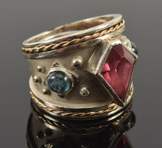 18K gold custom ring with pink and paraiba tourmalines. Faceted kite