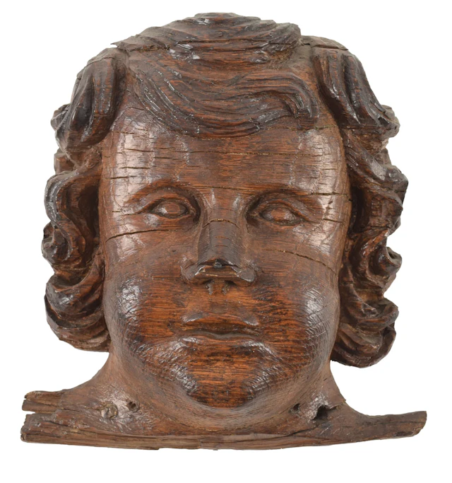 17th century carved wood cherub architectural fragment. 7.75in high.