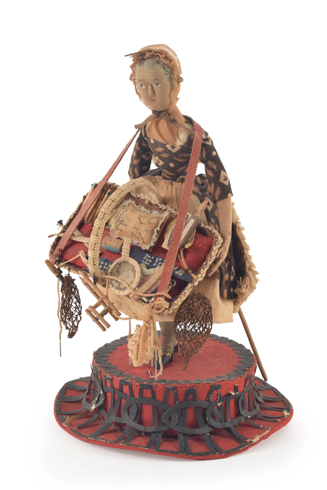 Early 19th century "Peddler" doll. Woman carrying basket of goods