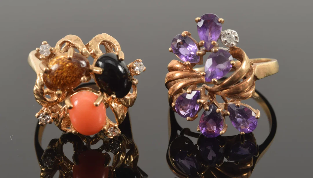 2 gold rings. 1) 14K gem set ring with coral, onyx, tiger's eye, and