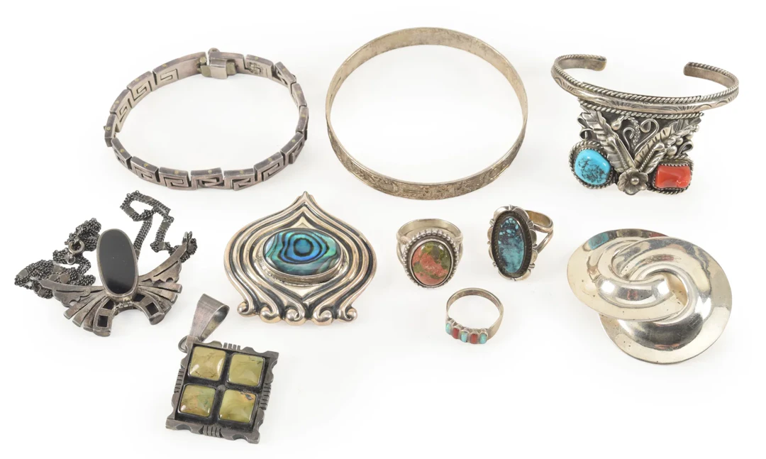 Selection of silver jewelry, including southwest style rings and cuff