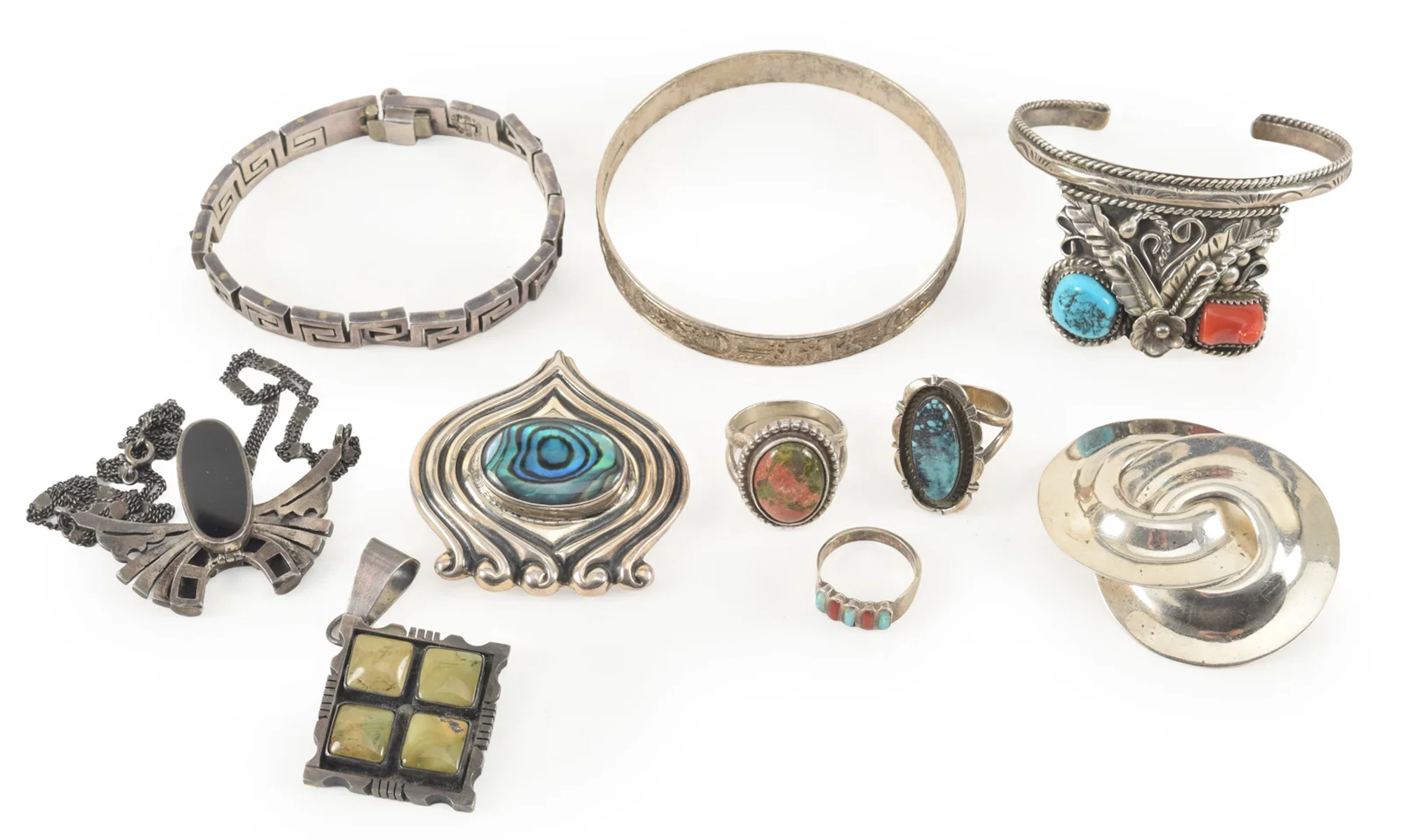 Selection of silver jewelry, including southwest style rings and cuff
